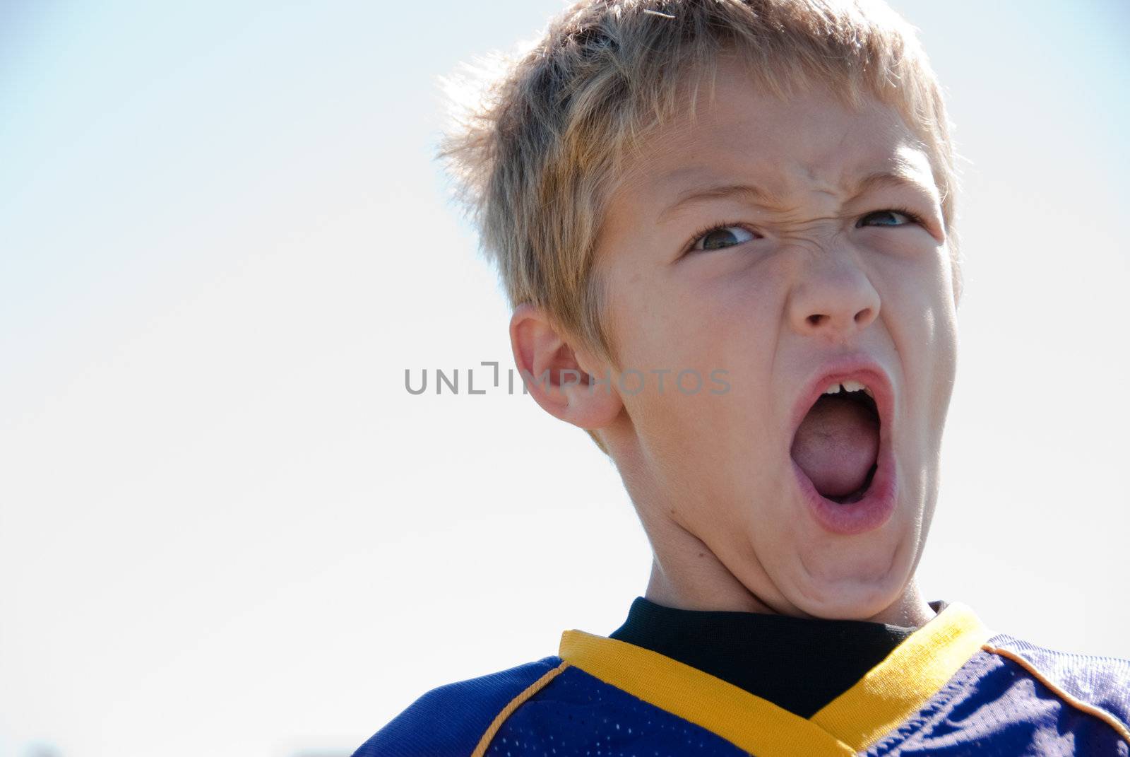 Young blonde boy yelling by tammykayphoto