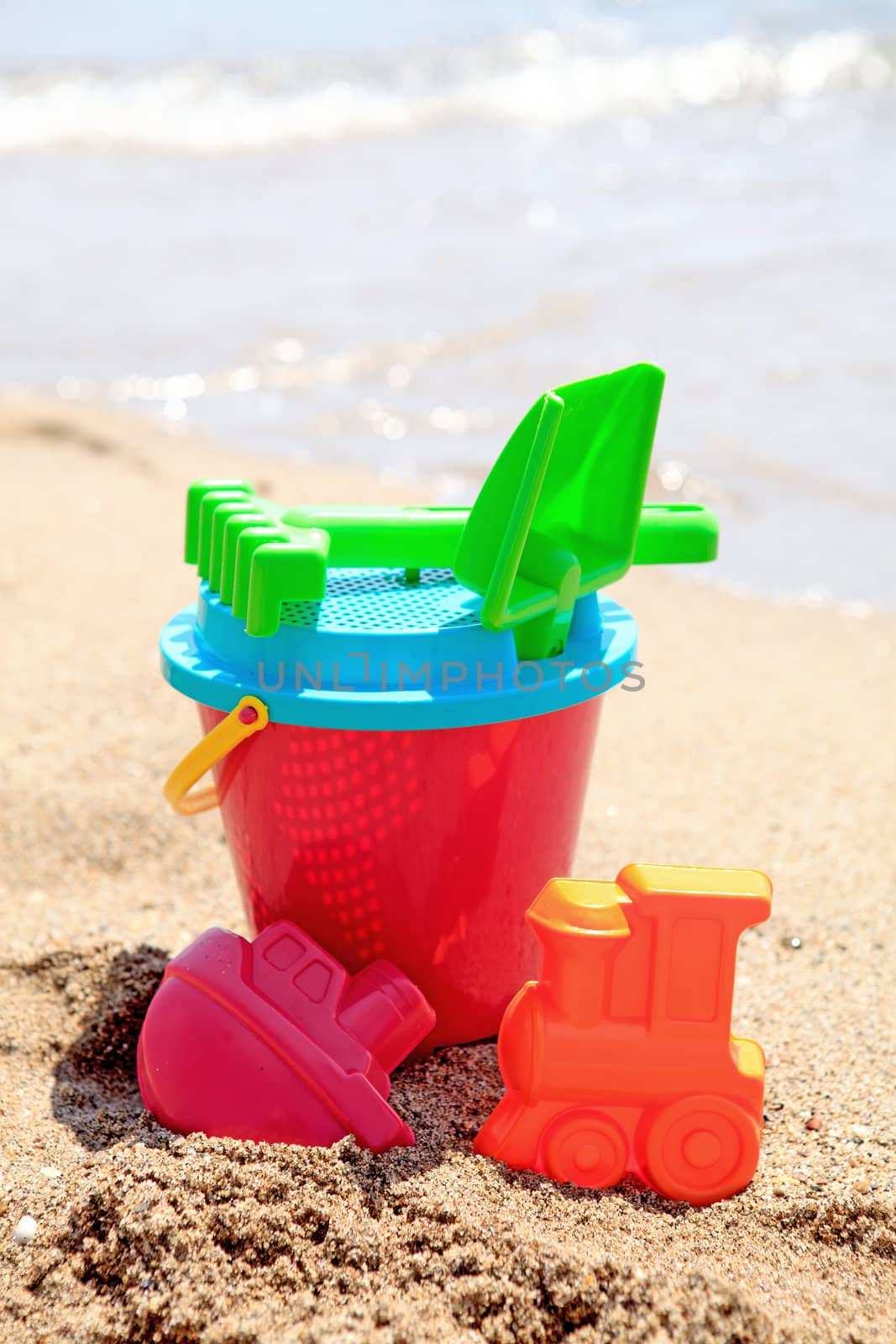 colorful plastic toys at the beach near the ocean
