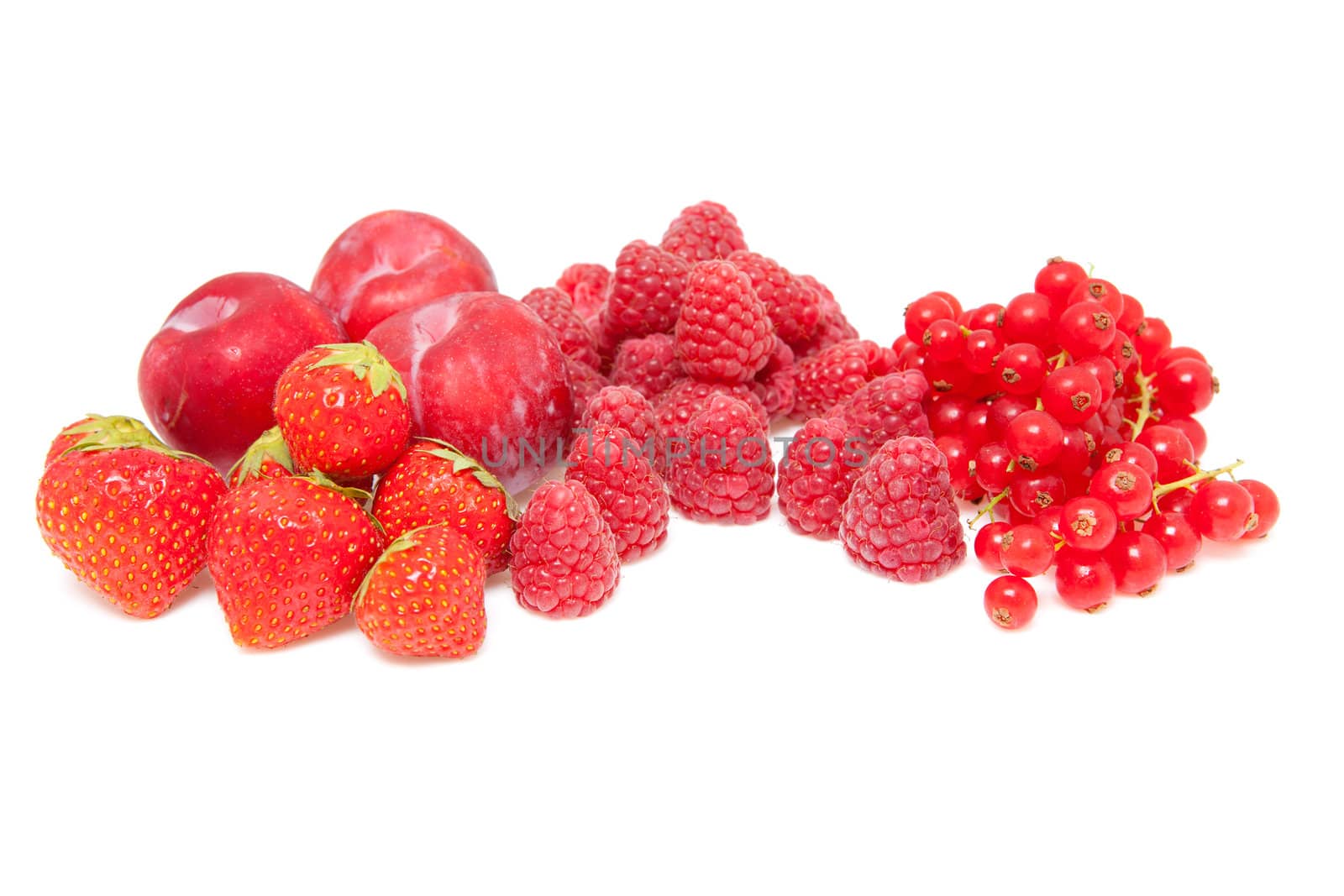 Fresh red fruits isolated on white background. raspberries, strawberries and plums