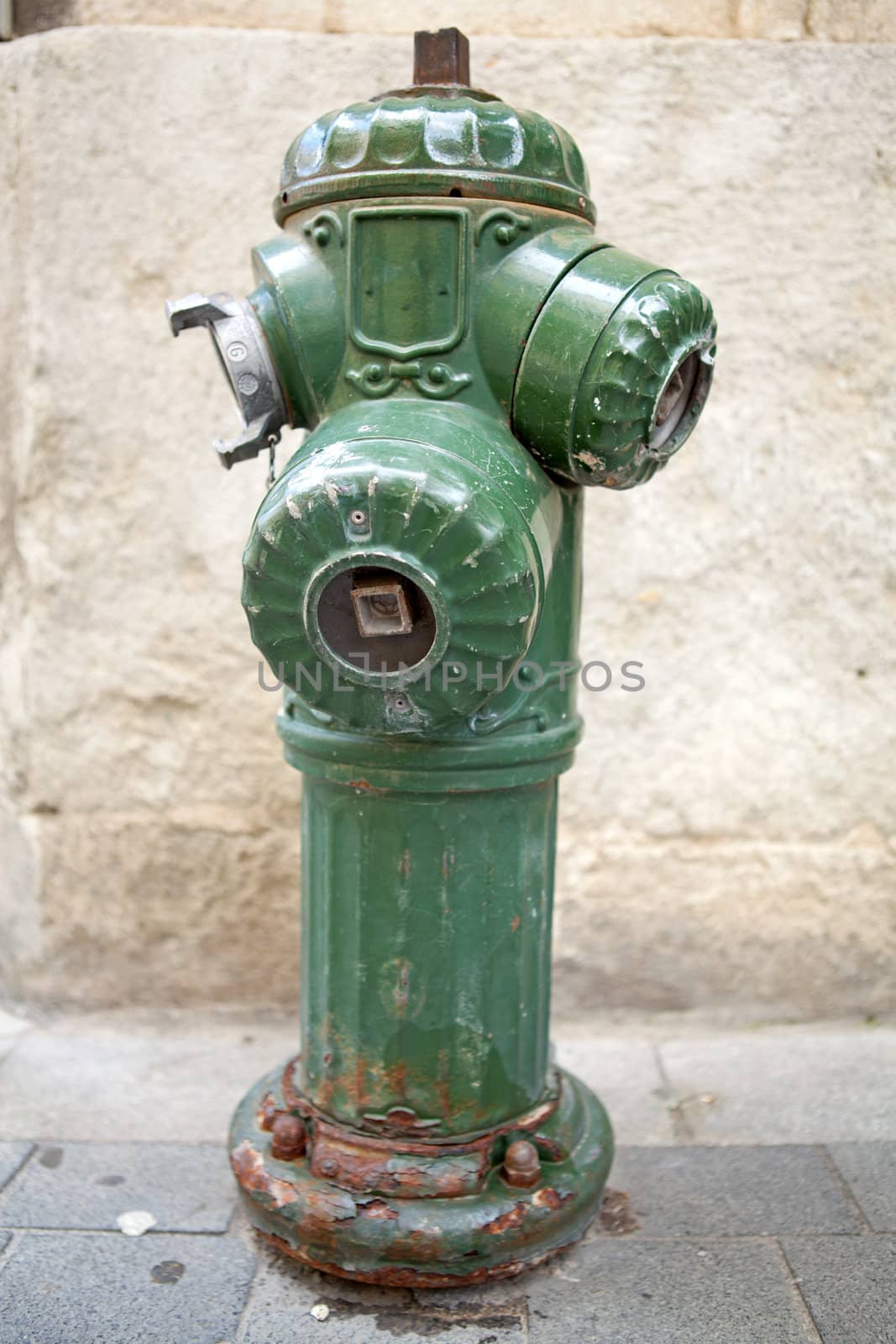 Old green fire hydrant in closeup