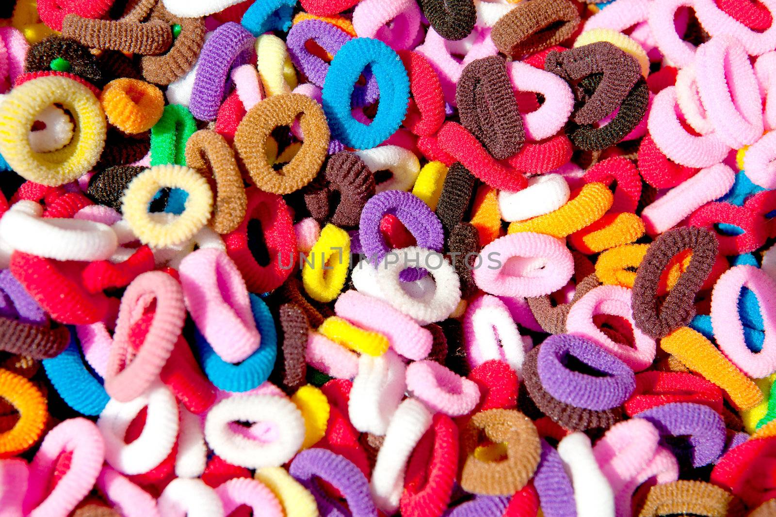 background of colorful hair elastics in closeup