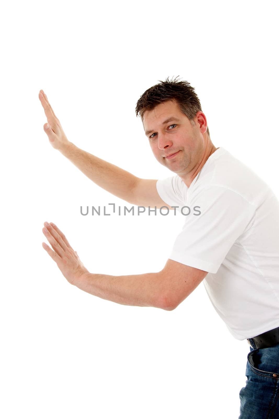 isolated man in white t-shirt is leaning or pushing nothing and looking in camera