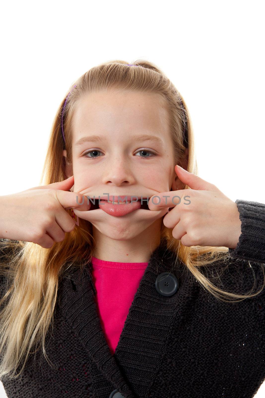 Girl is making funny face, she sticks her tongue out over white background