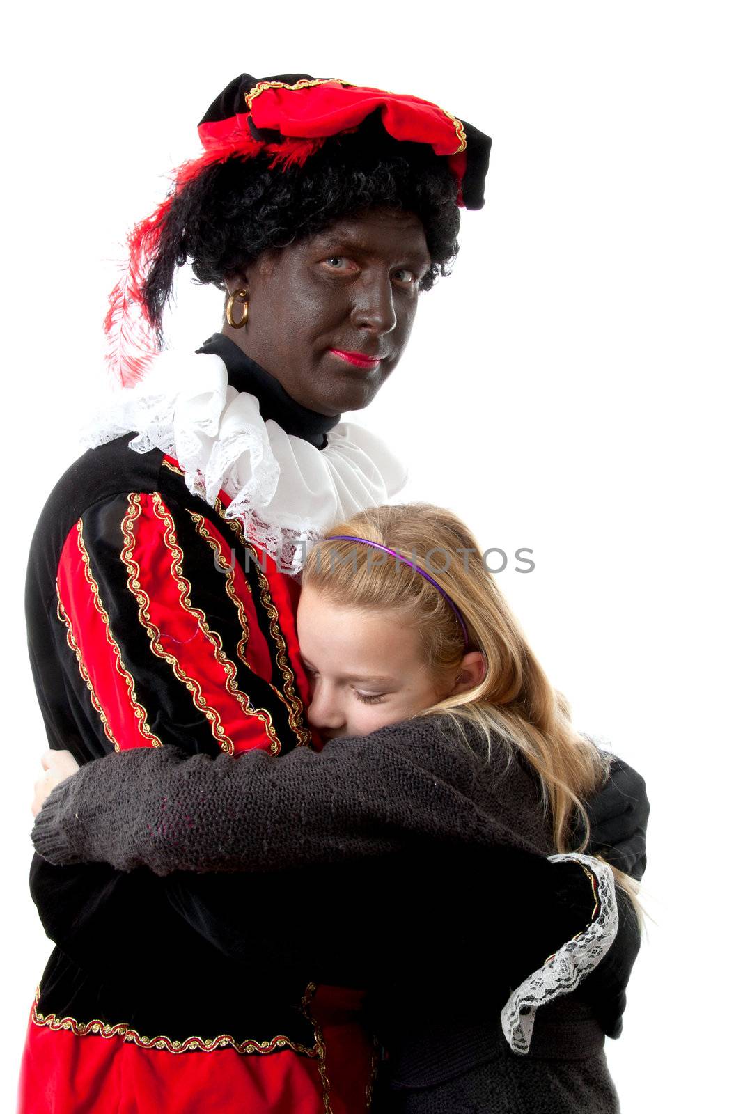 girl is hugging black pete ( typical Dutch event in december with character zwarte piet) over white background