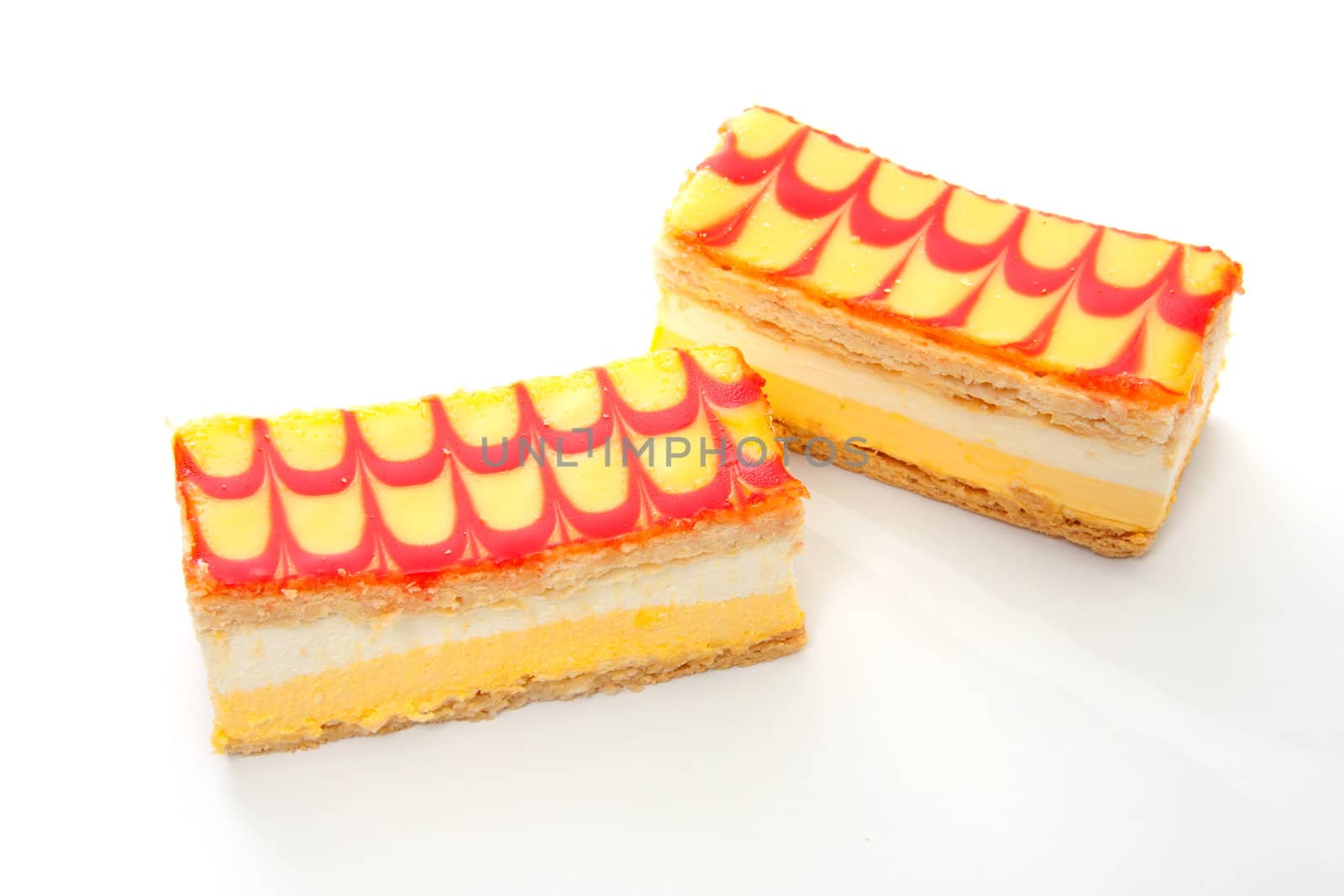 two delicious yellow Tompouce pastry isolated over white background