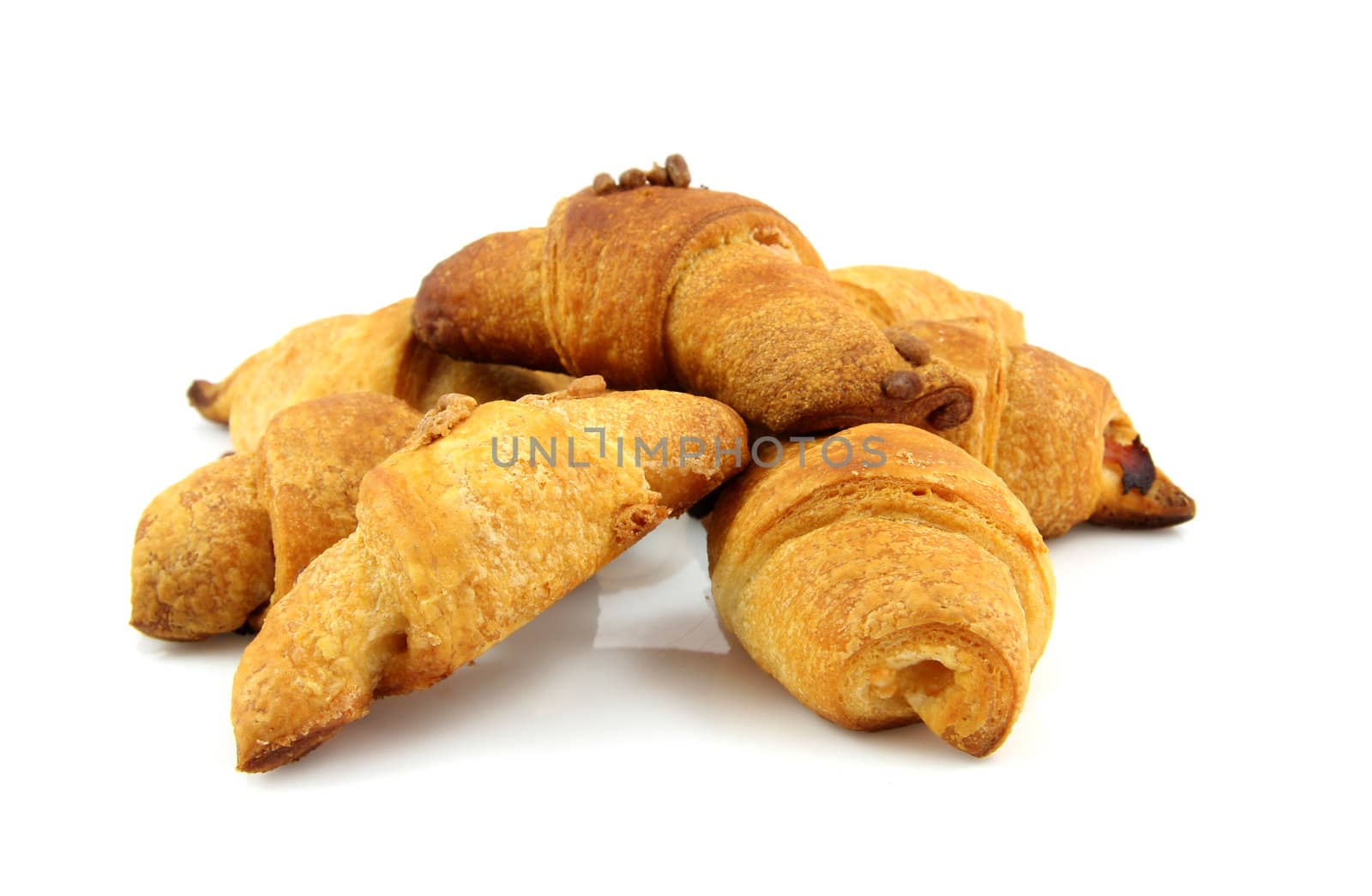 pile of home baked croissants over white background