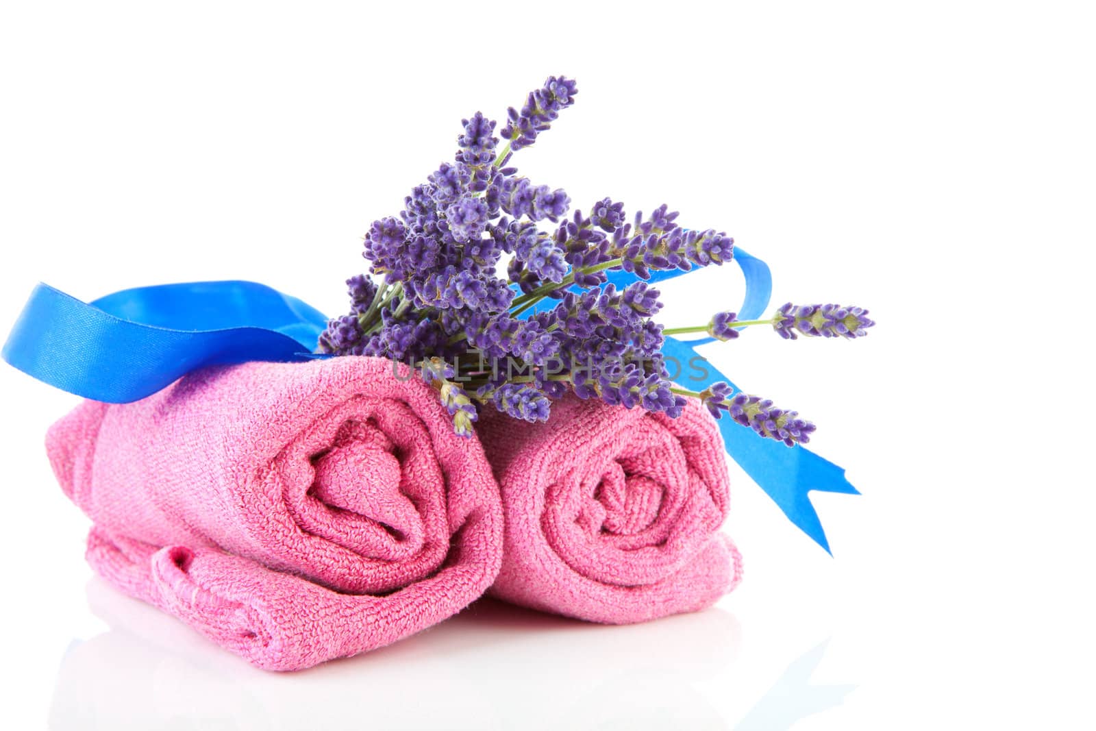 spa accessories with lavender and pink towels over white background