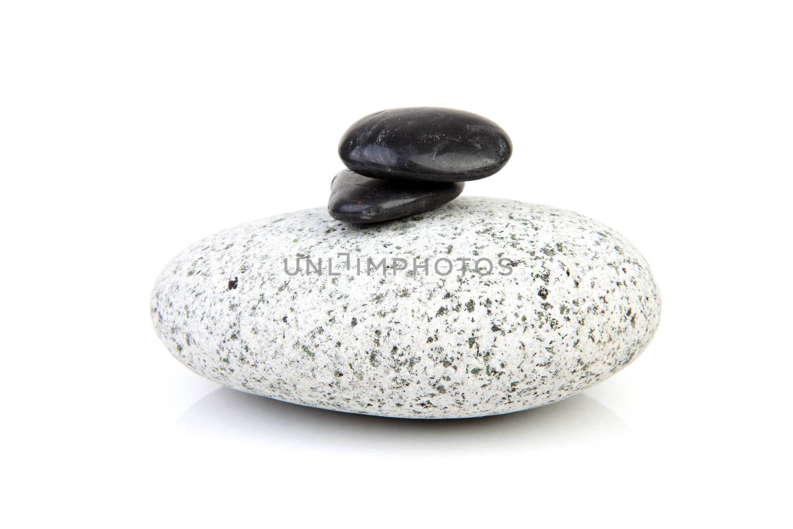 big grey rock with little back ones on thop over white background