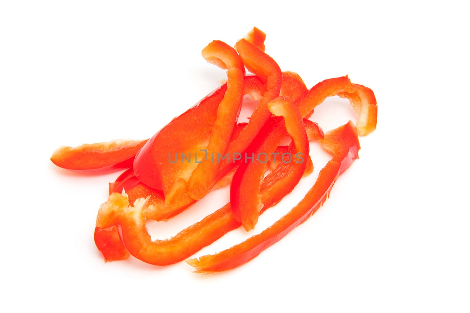 slices of red paprika over white background