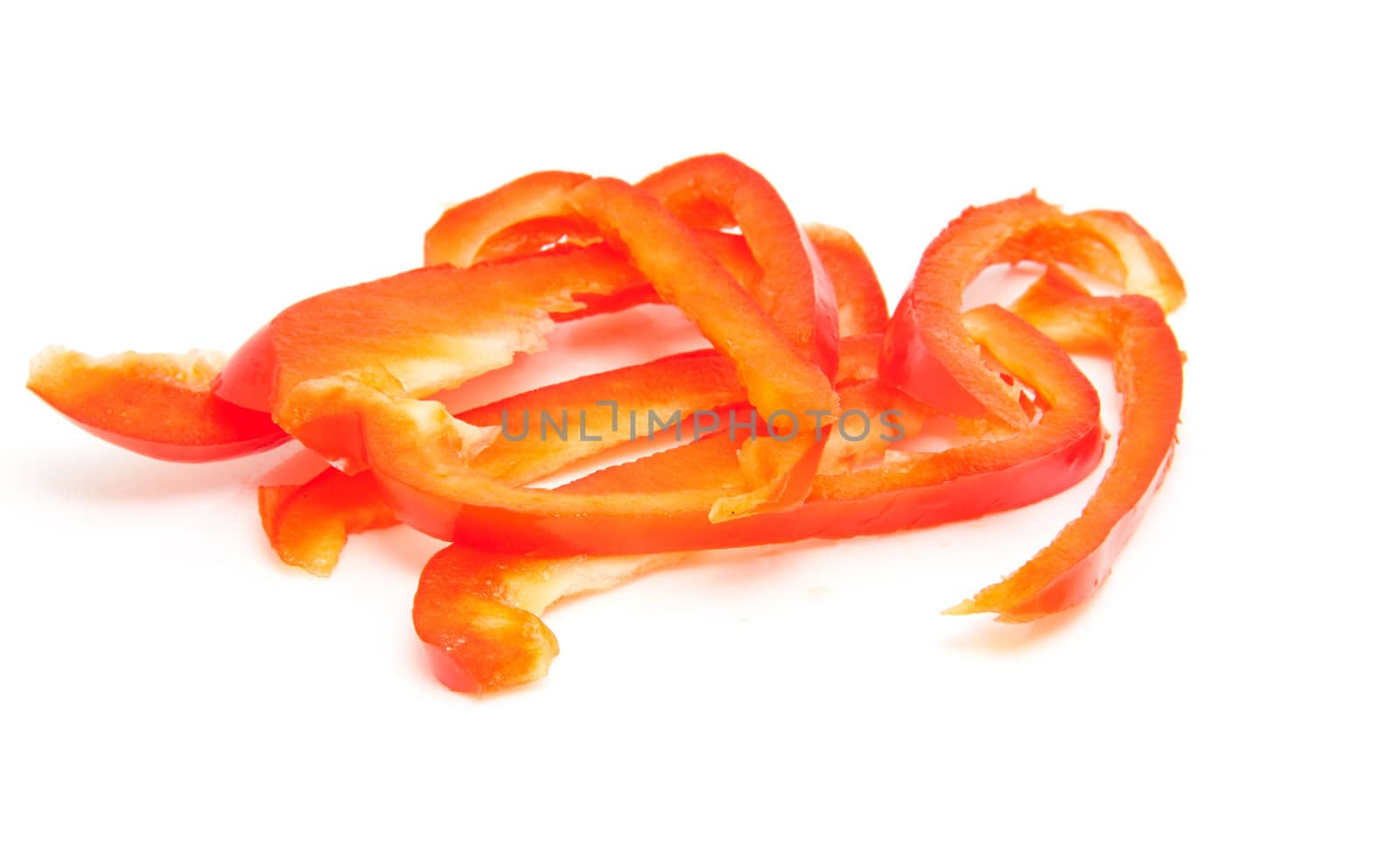 slices of red paprika over white background