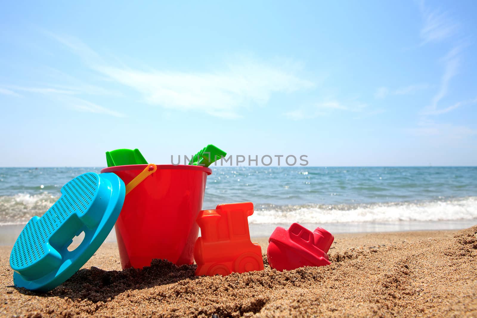 colorful plastic toys at the beach near the ocean