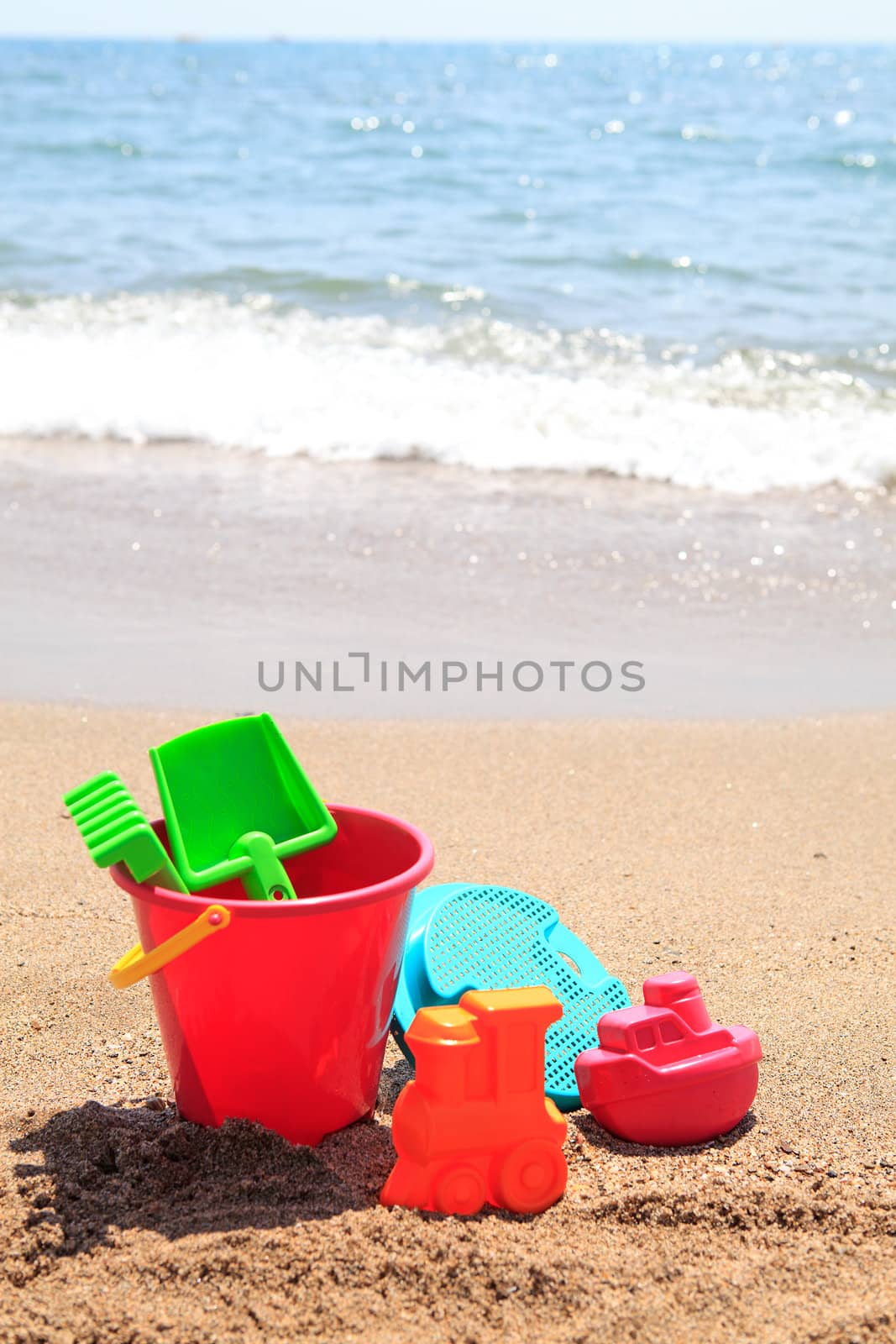 colorful plastic toys at the beach near the ocean