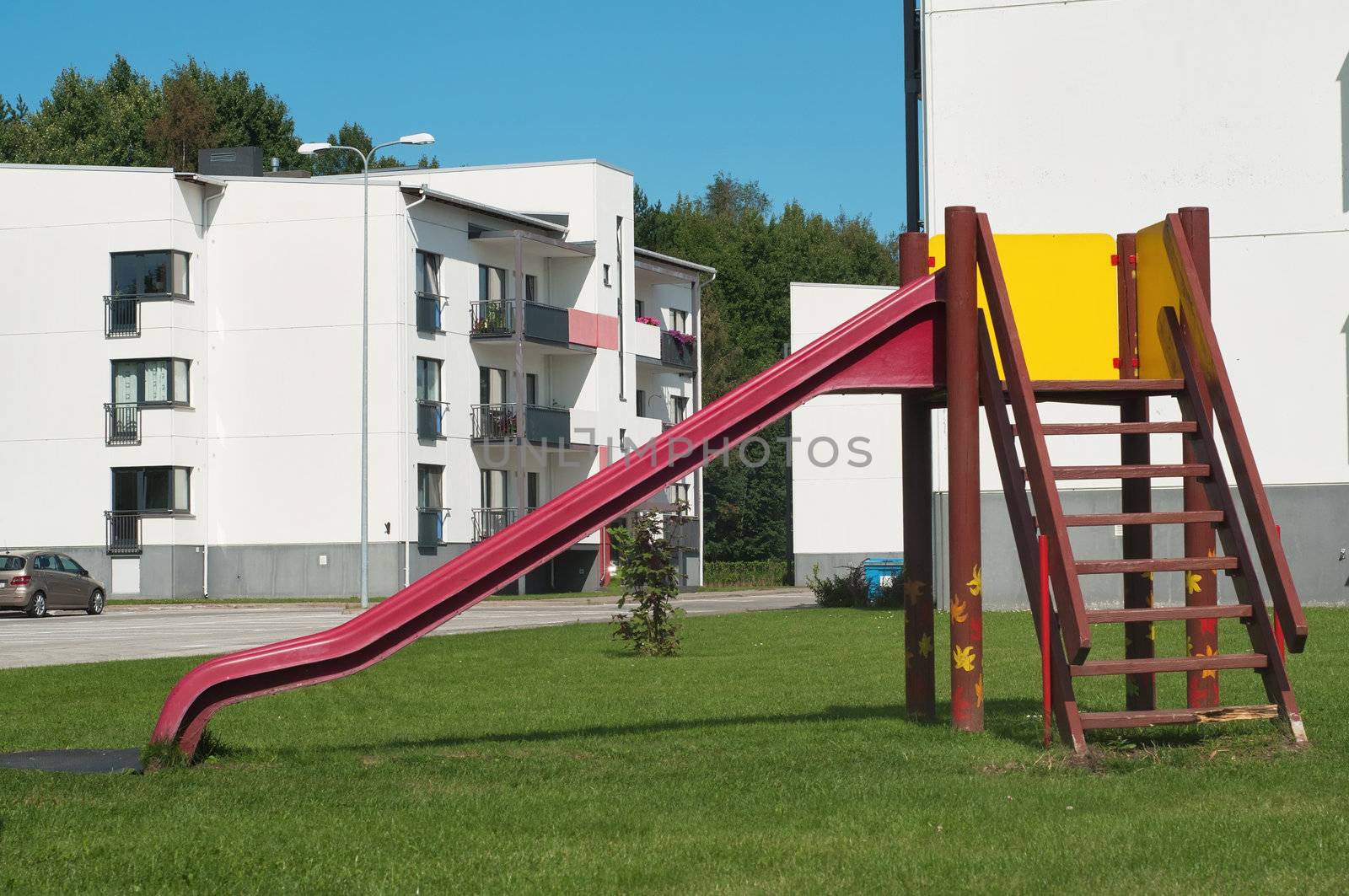 Children's playground near residential area, white houses