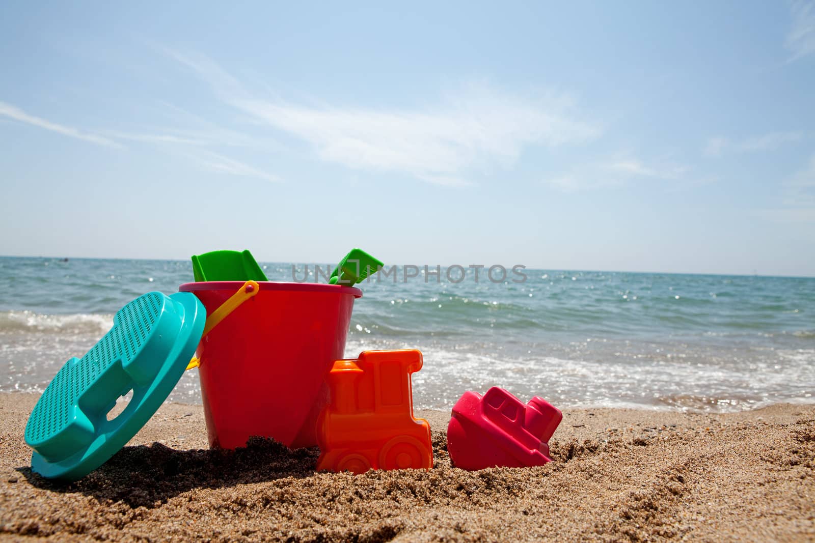 plastic colorful toys at the beach near the ocean