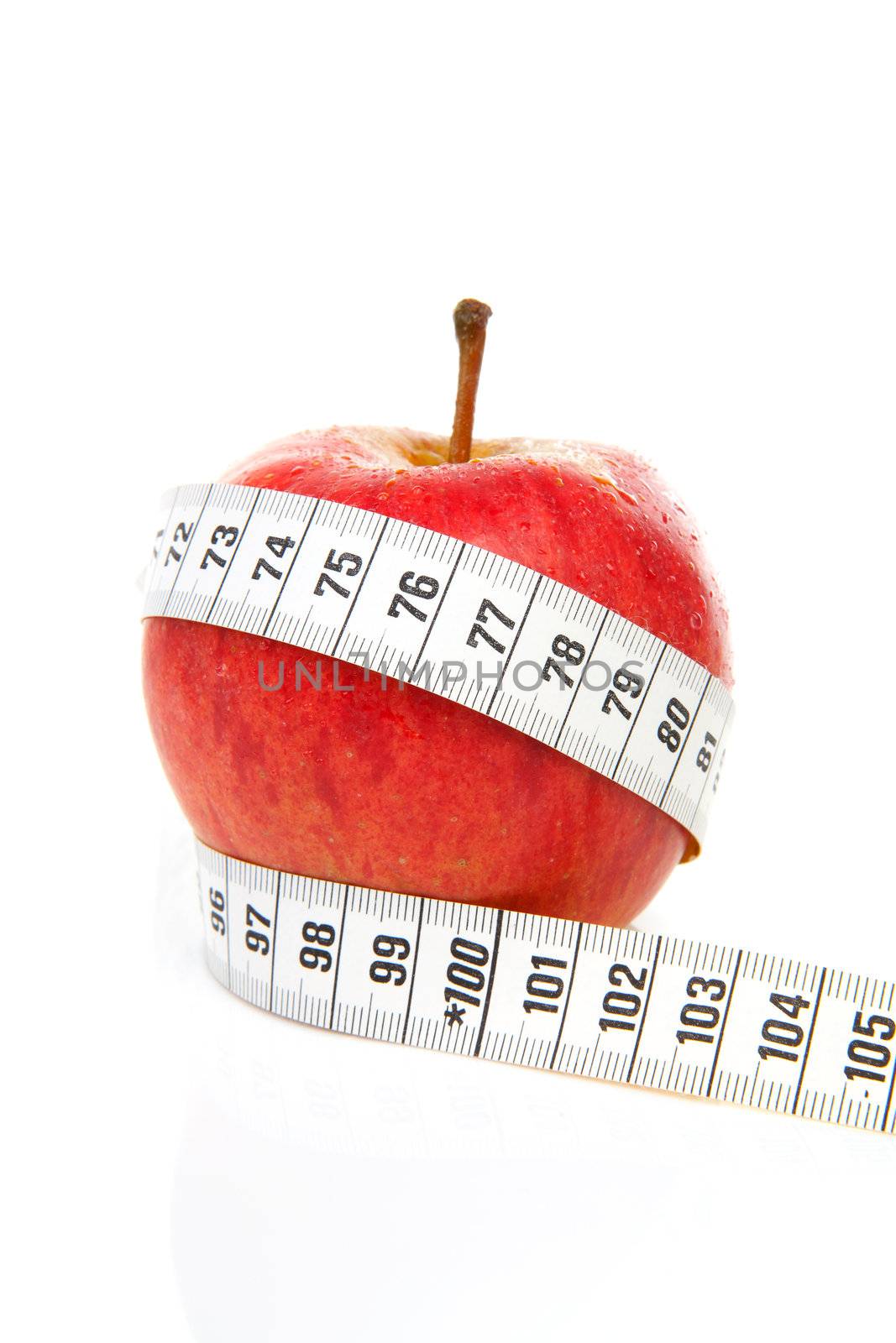 healthy diet; red apple with measure tape over white background