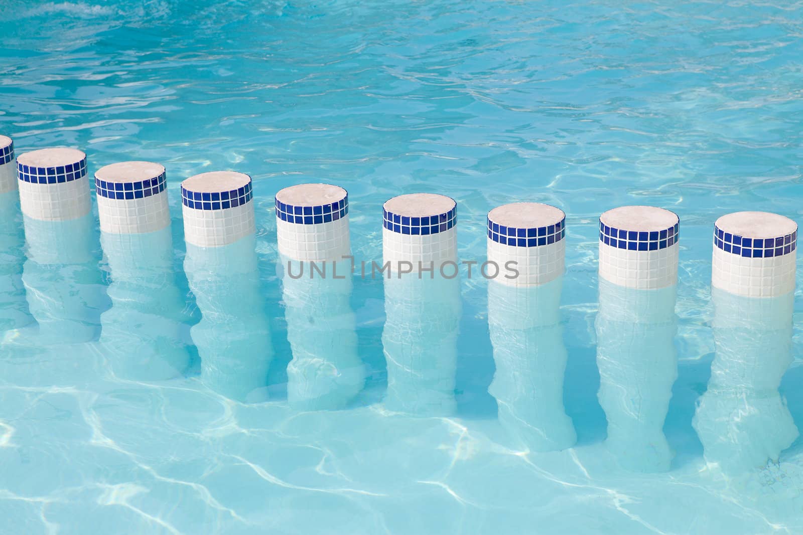 poles in the water of a swimming pool