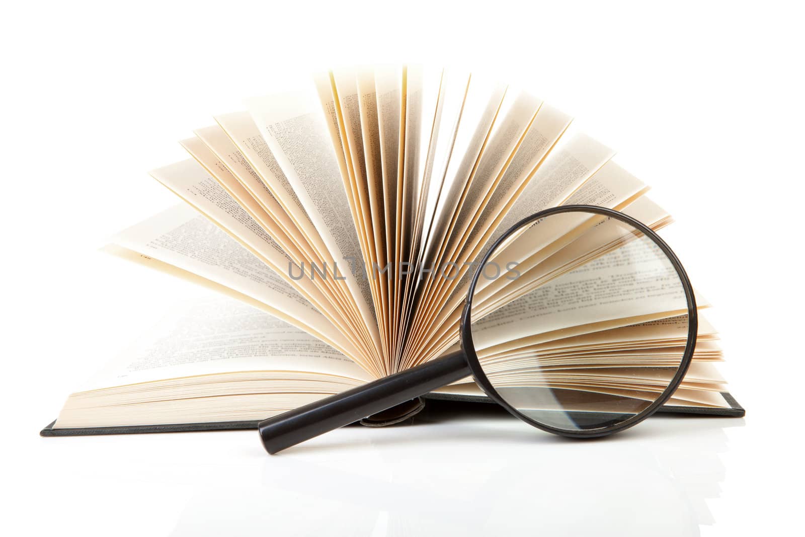 open book with magnifying glass over white background