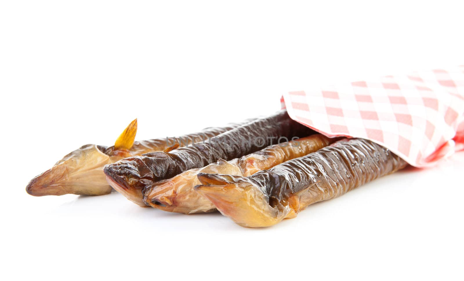 pile of Dutch smoked eel under napkin isolated on white background