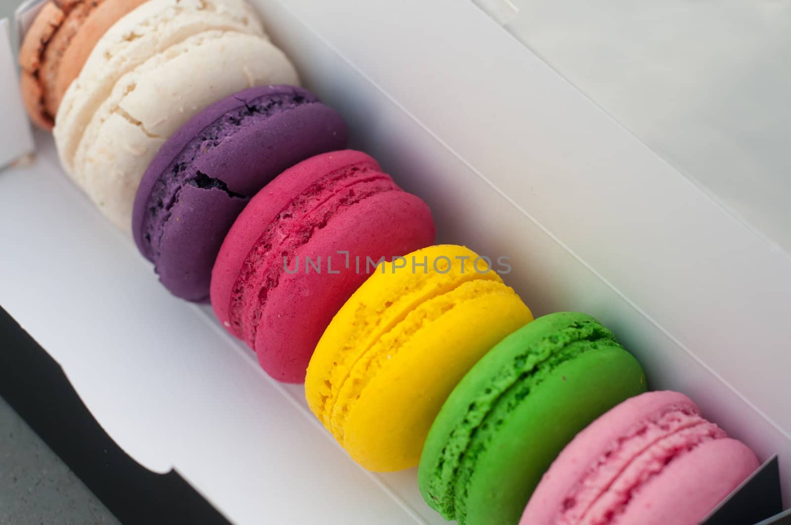 Multicolored french macarons cookies in b/w box