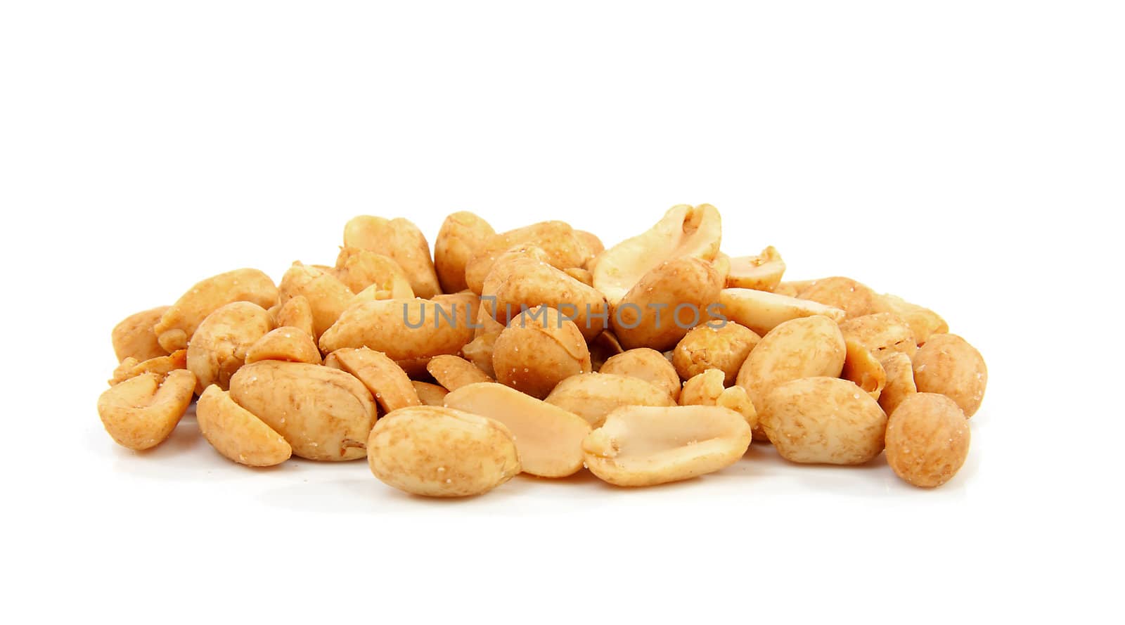 salted peanuts in closeup over white background