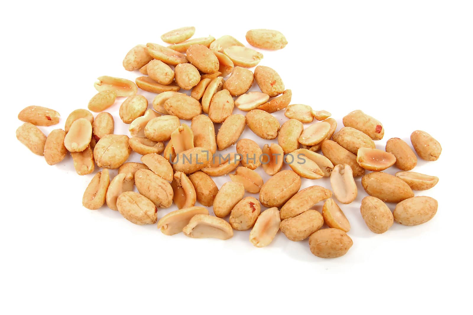 salted peanuts in closeup over white background