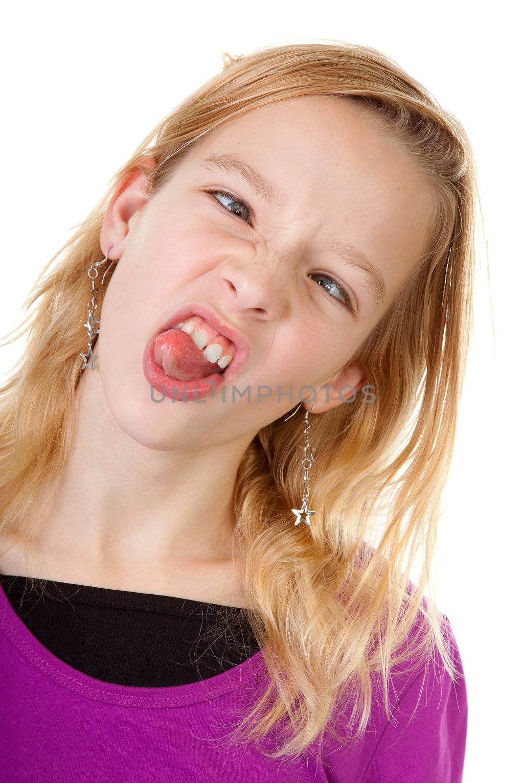 young girl makes funny face in closeup over white background