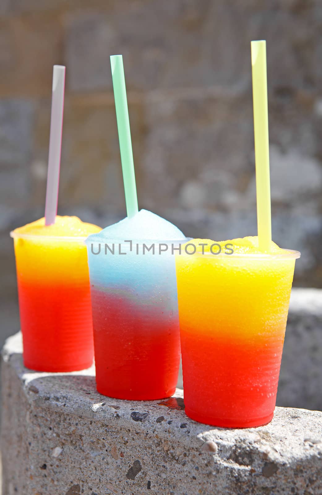 colorful slushy ice drinks in plastic cups