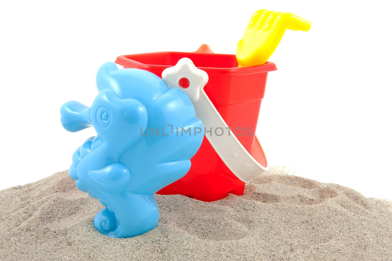 colorful plastic play toys for the bach over white background