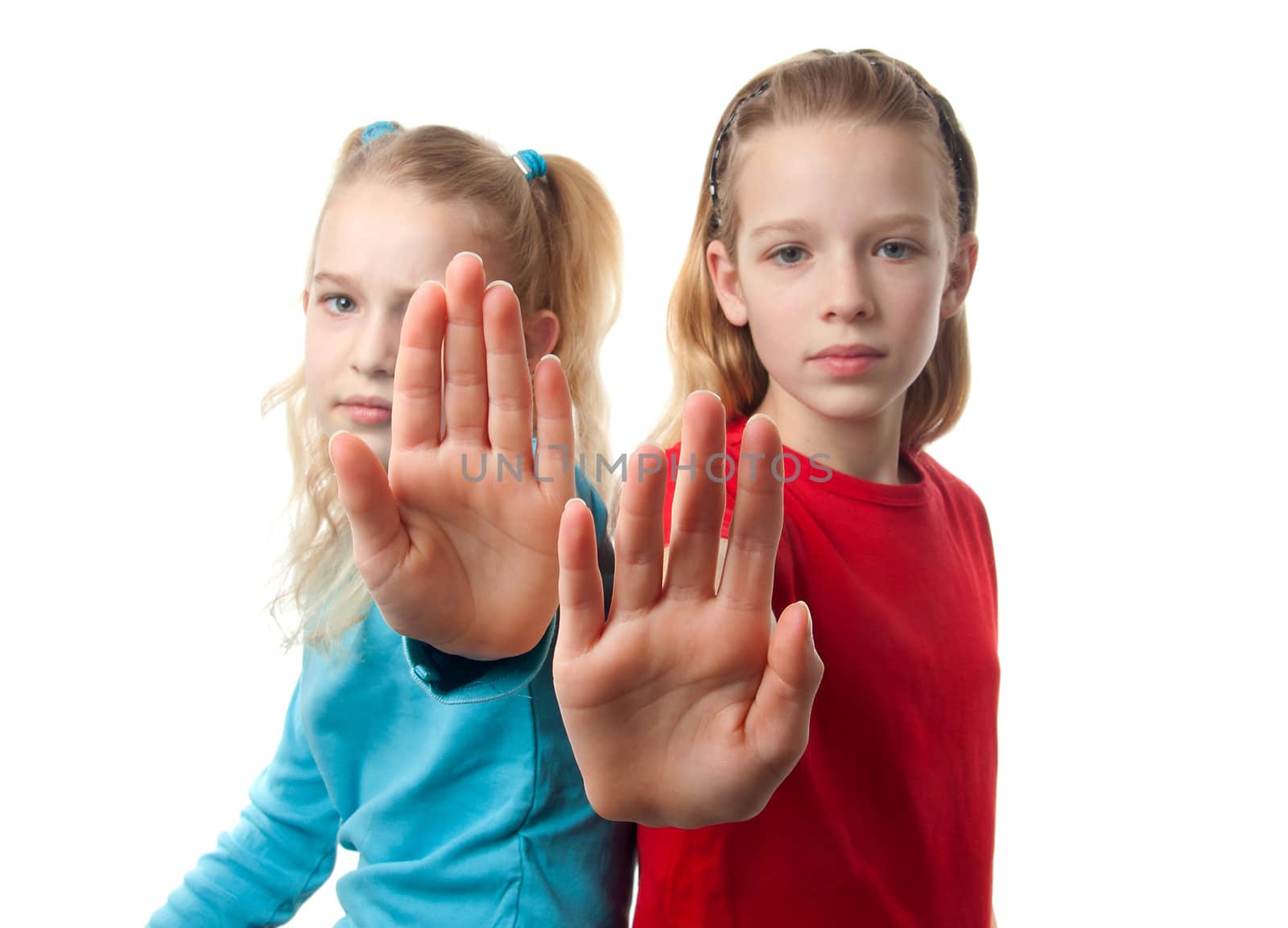 two caucasian girls making stop sign with focus on hands over white background