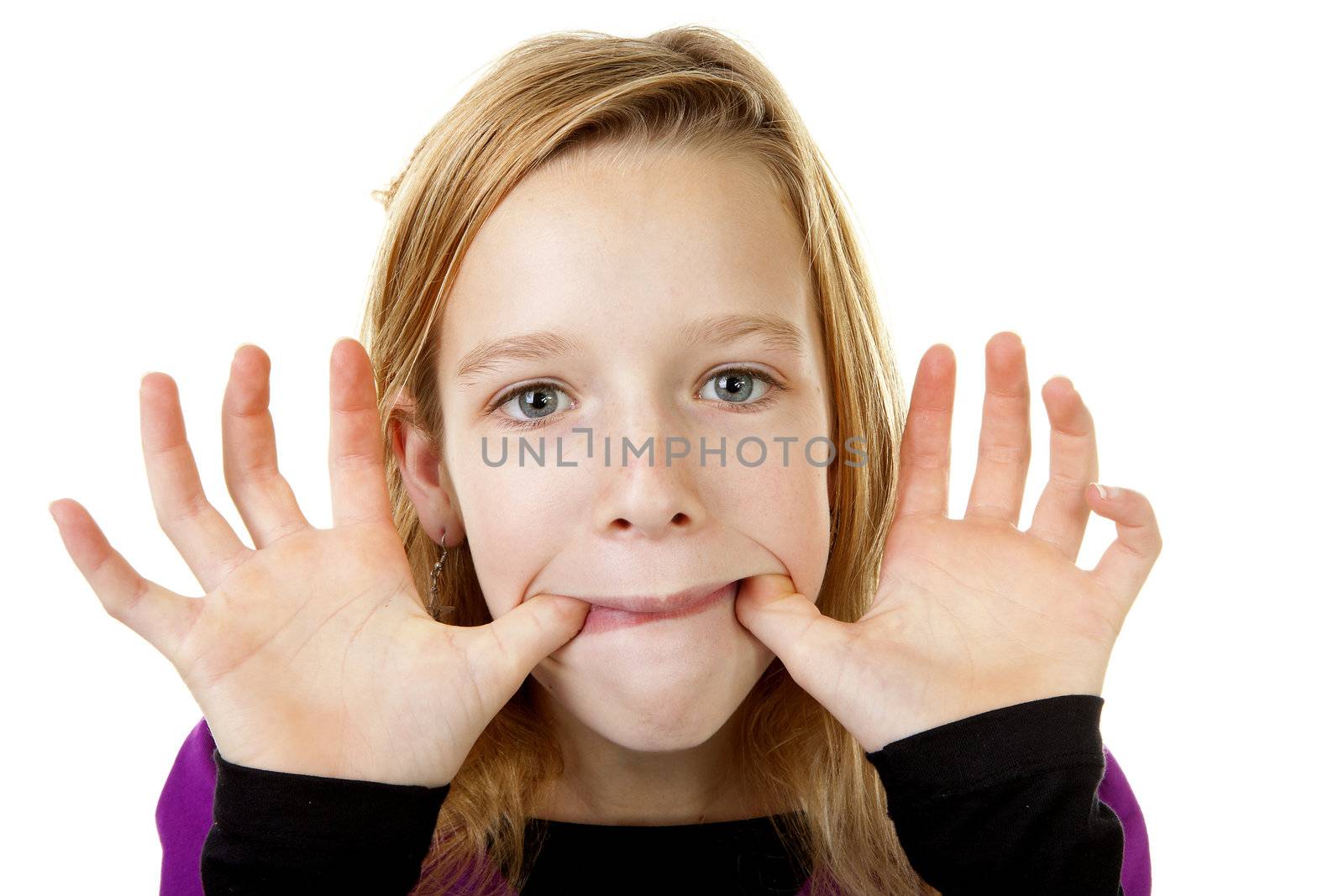 girl is making funy face in closeup over white background