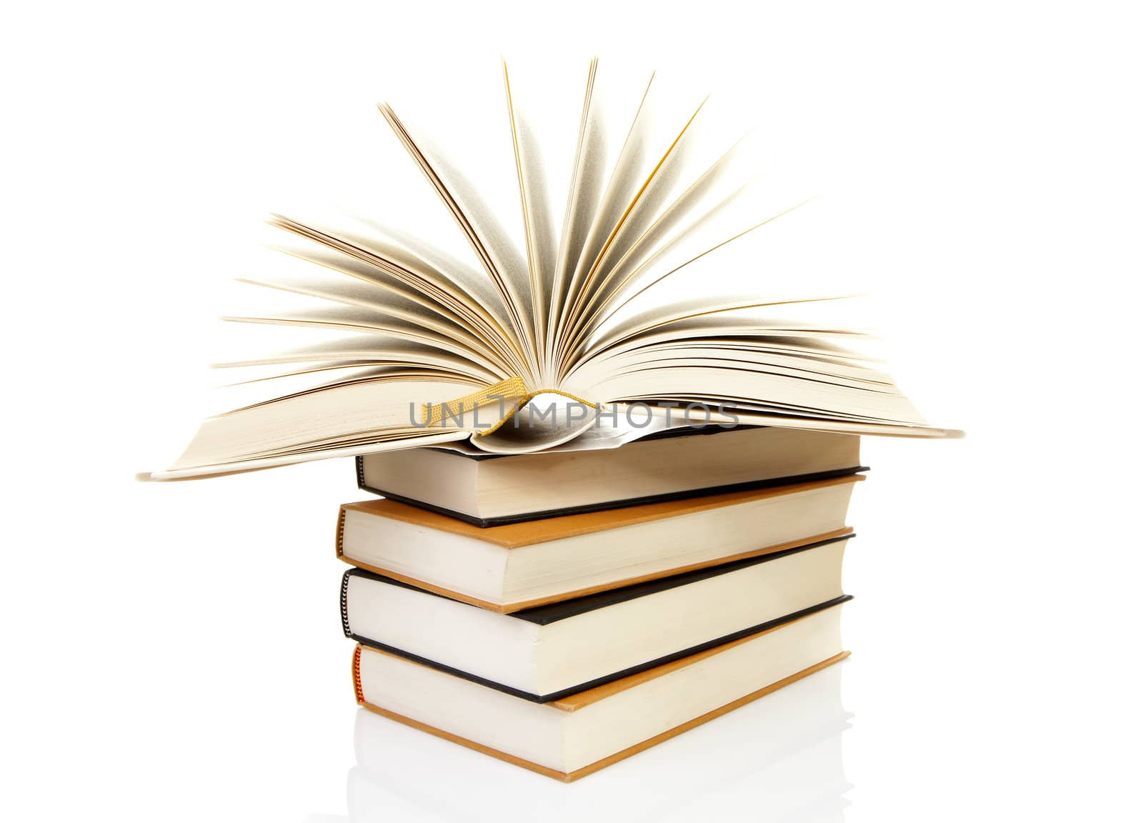 stack of books with open book over white background 
