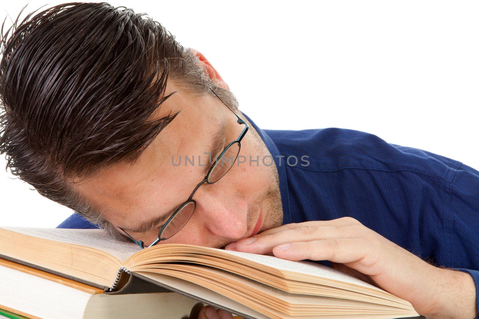 male nerdy geek fall asleep with face on pile of books over white background