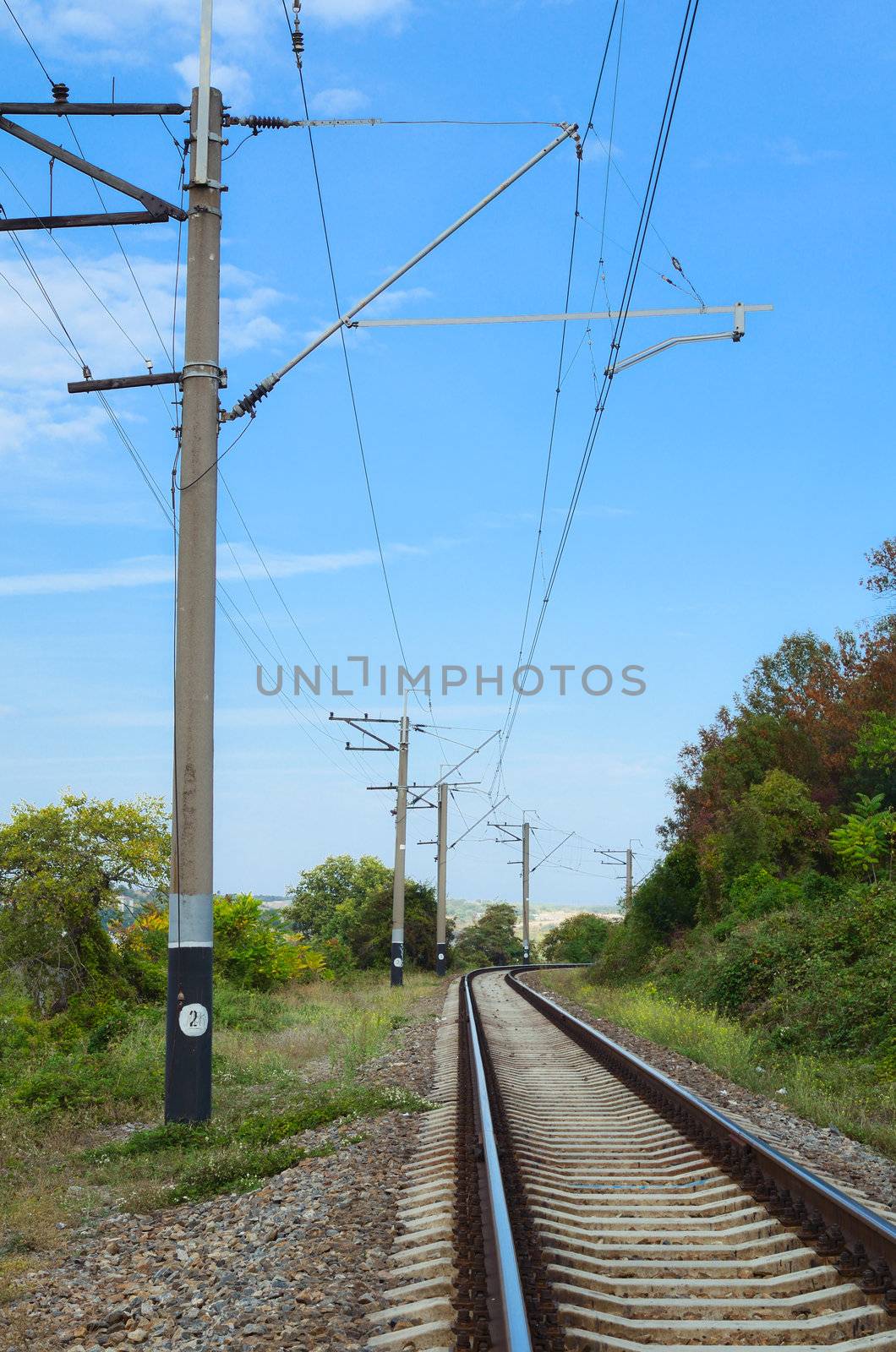 Railway track  cutting through rural countryside in summer