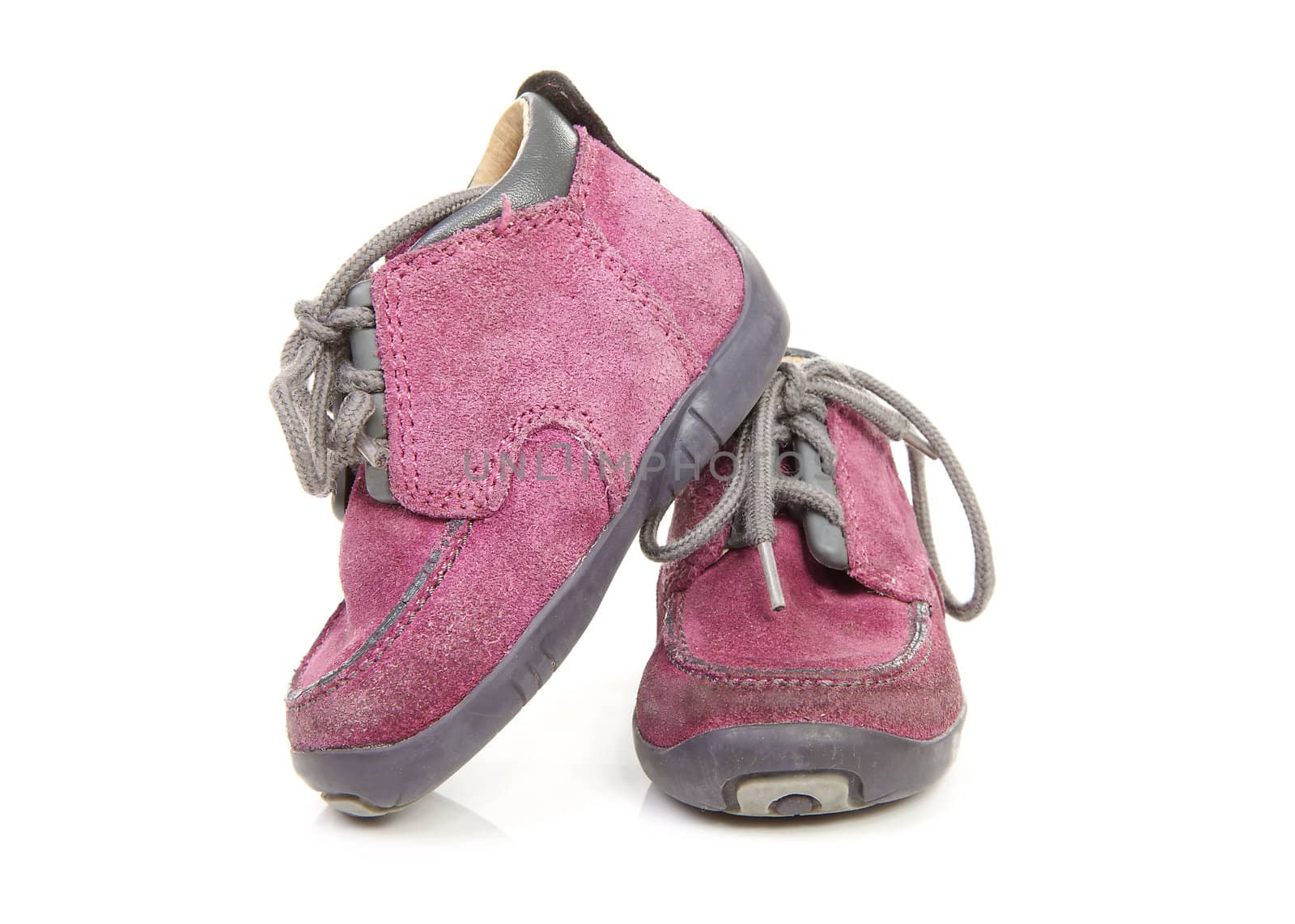 pair of purple children's shoes worn over white background