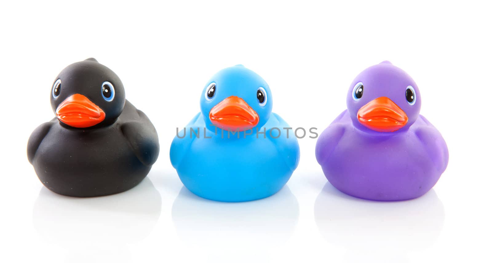 Three colorful rubber ducks isolated on white background