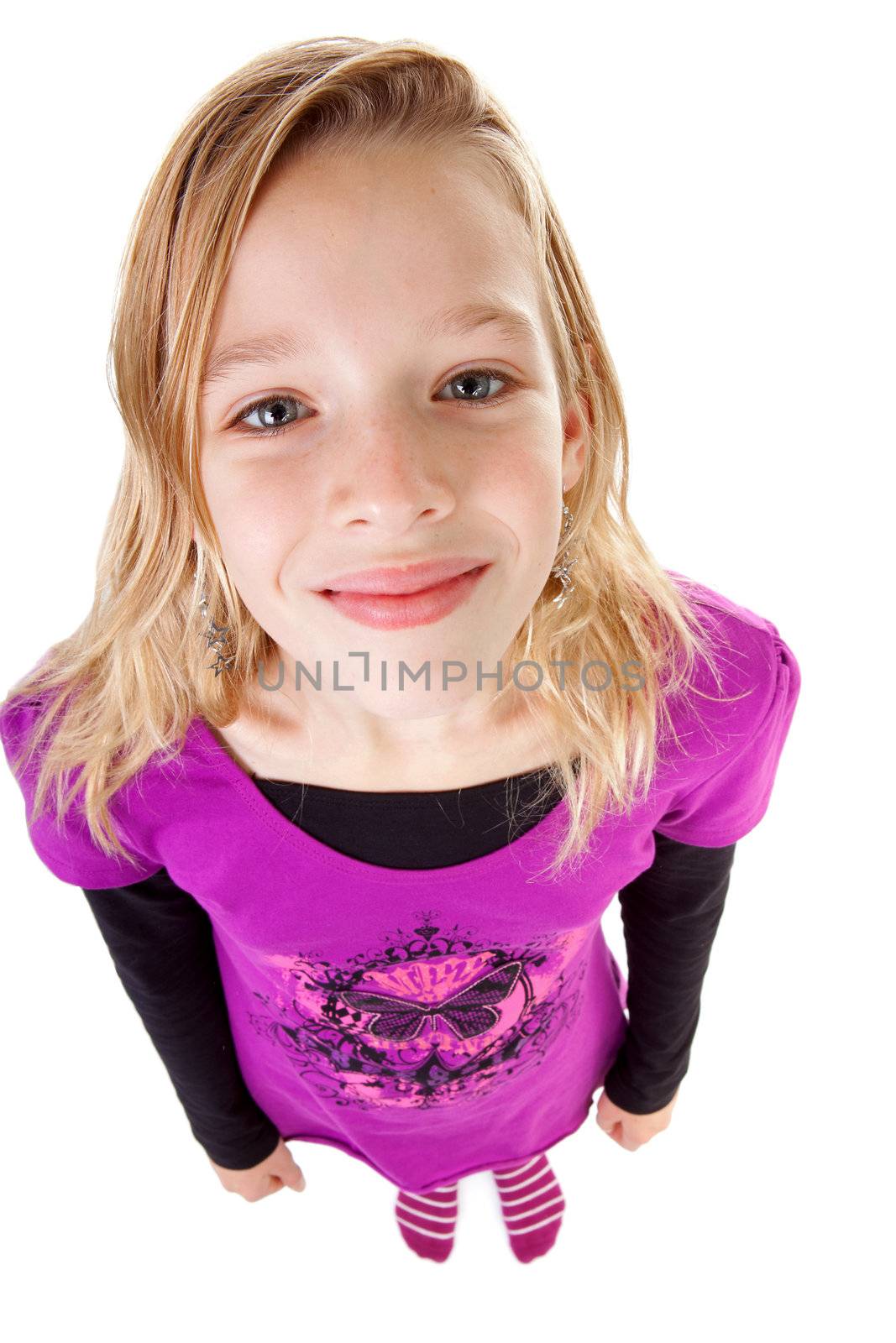 teenage girl in studio seen from above; big head little feet over white background