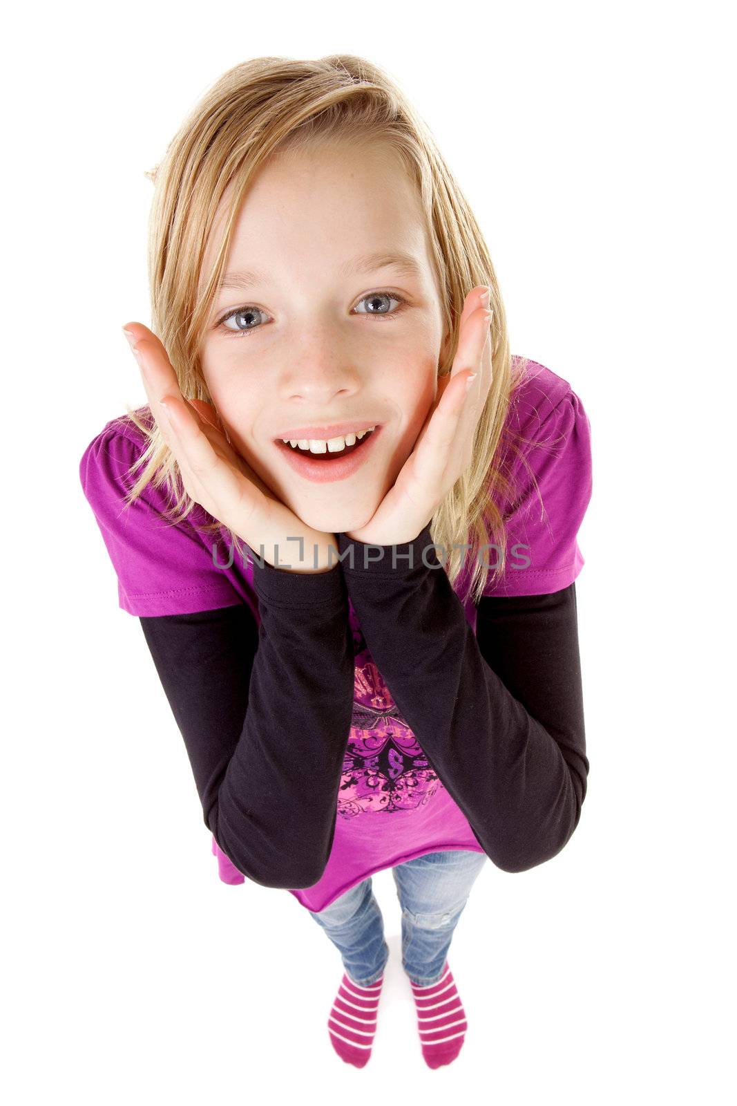 teenage girl in studio seen from above is looking surprised, over white background