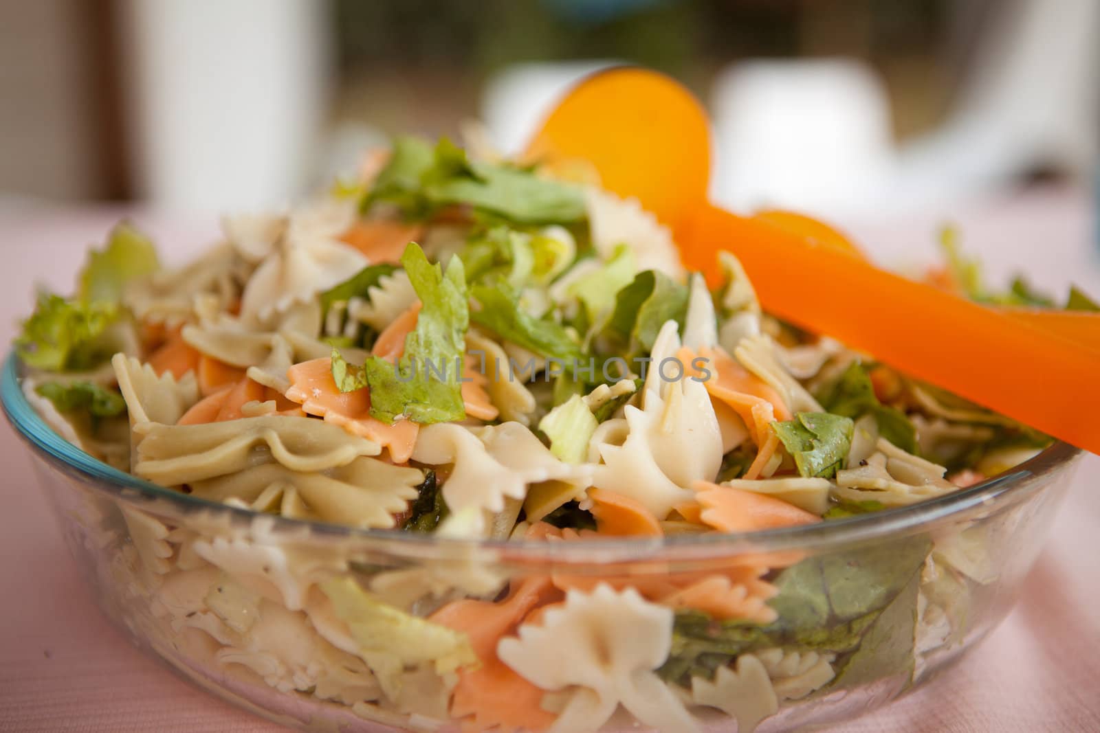 Fresh salad with pasta in closeup
