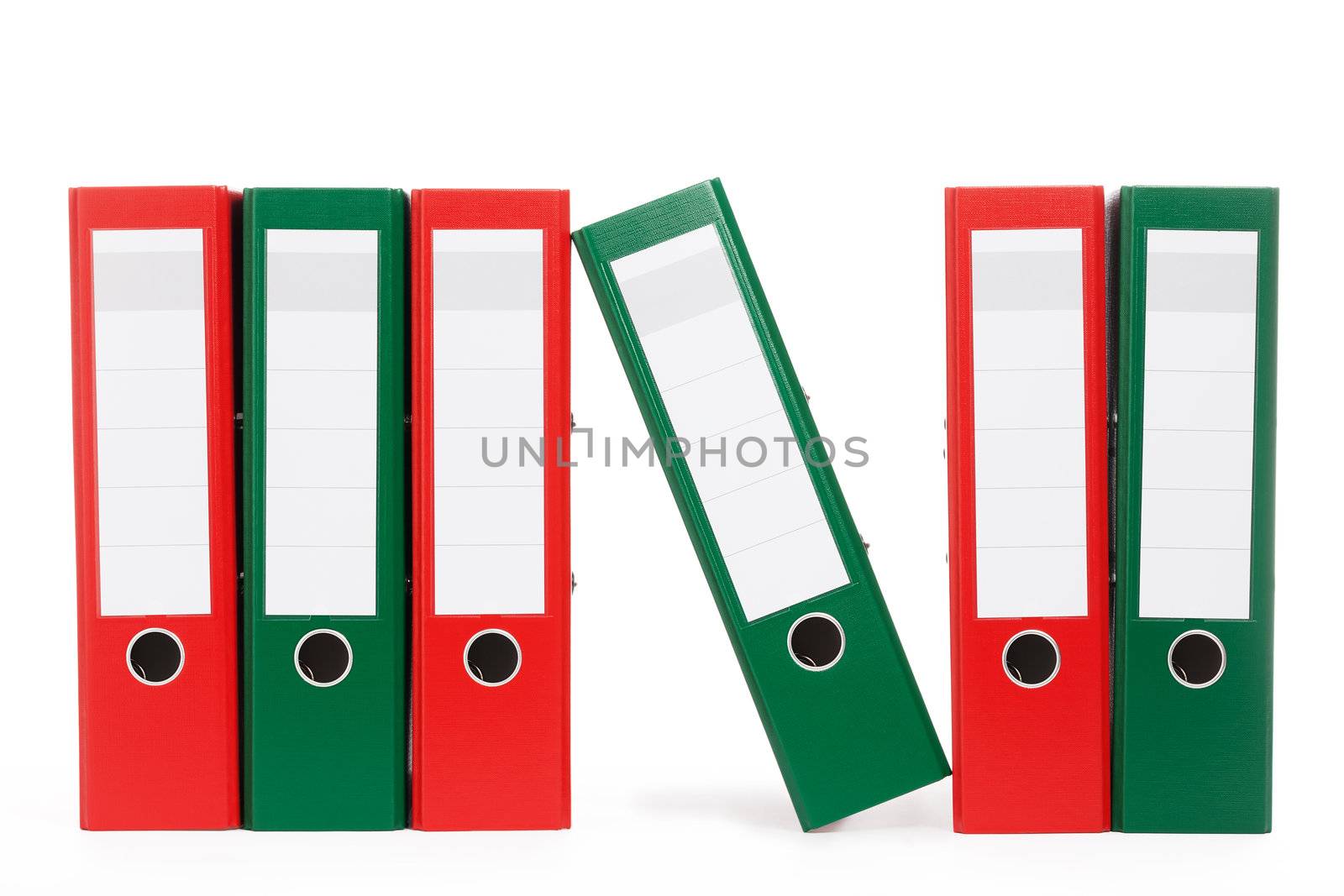 row of ring binders with one aslope on white background