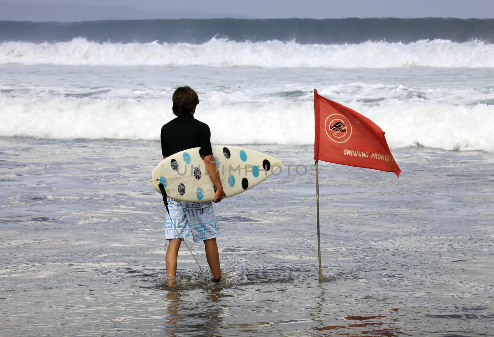 Surfer on a coastline expecting the big wave. Bali
