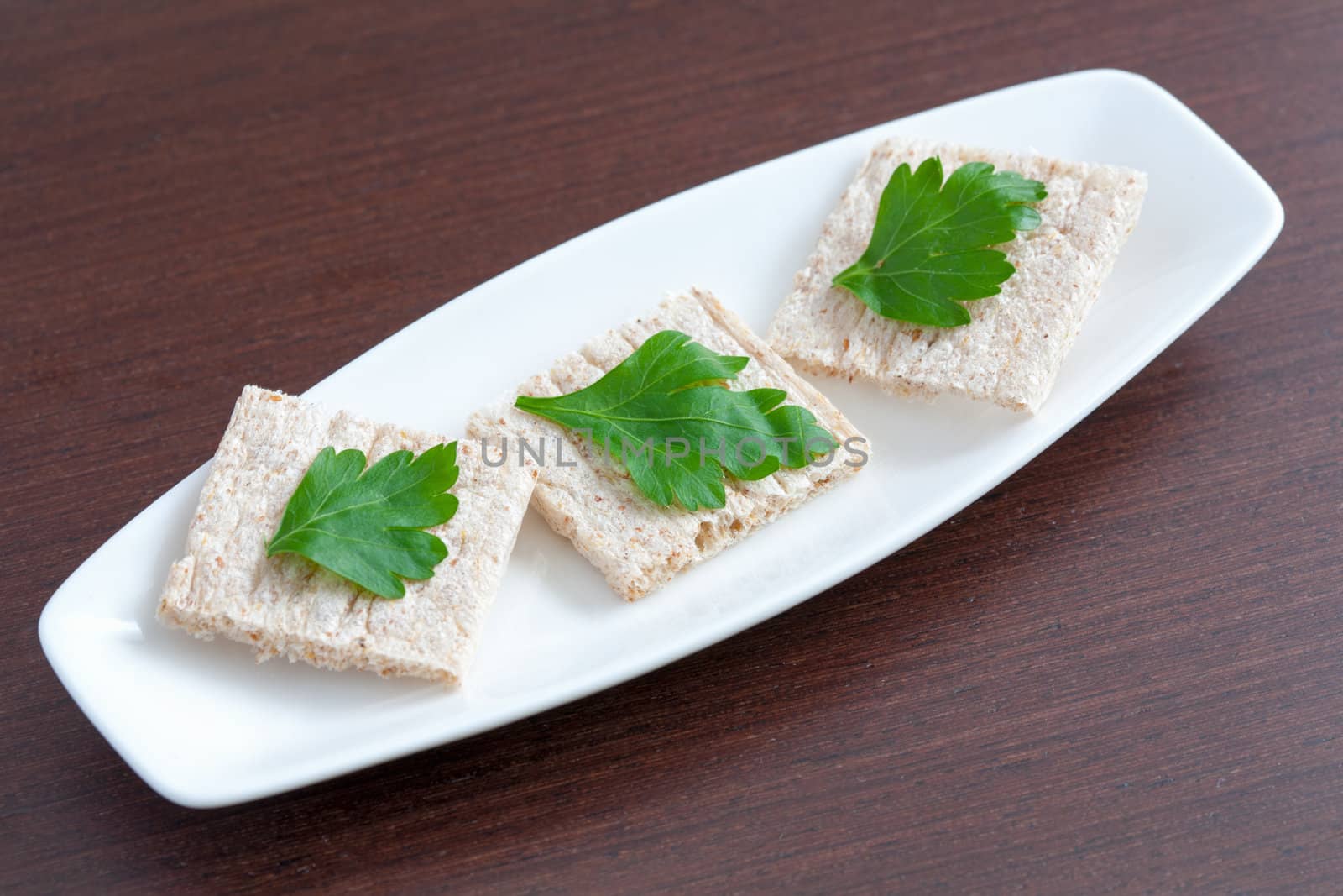 Diet bread with parsley on a plate by sfinks