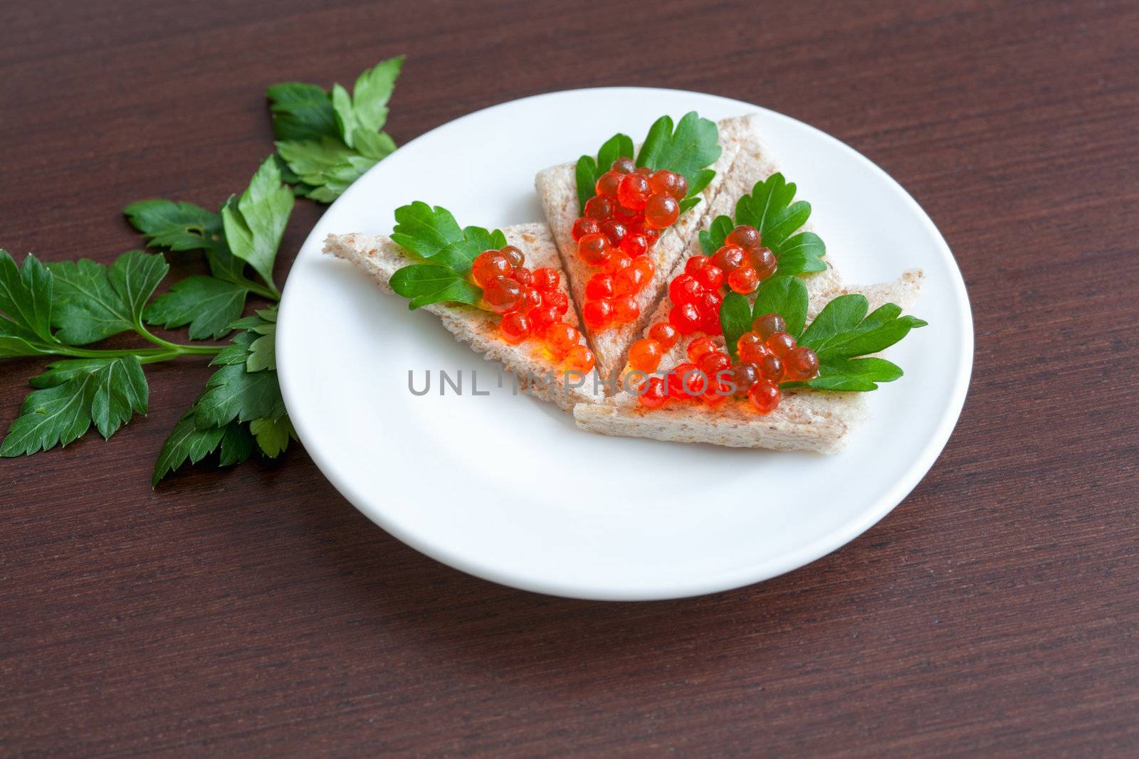 Tartlets with caviar and parsley on a plate by sfinks