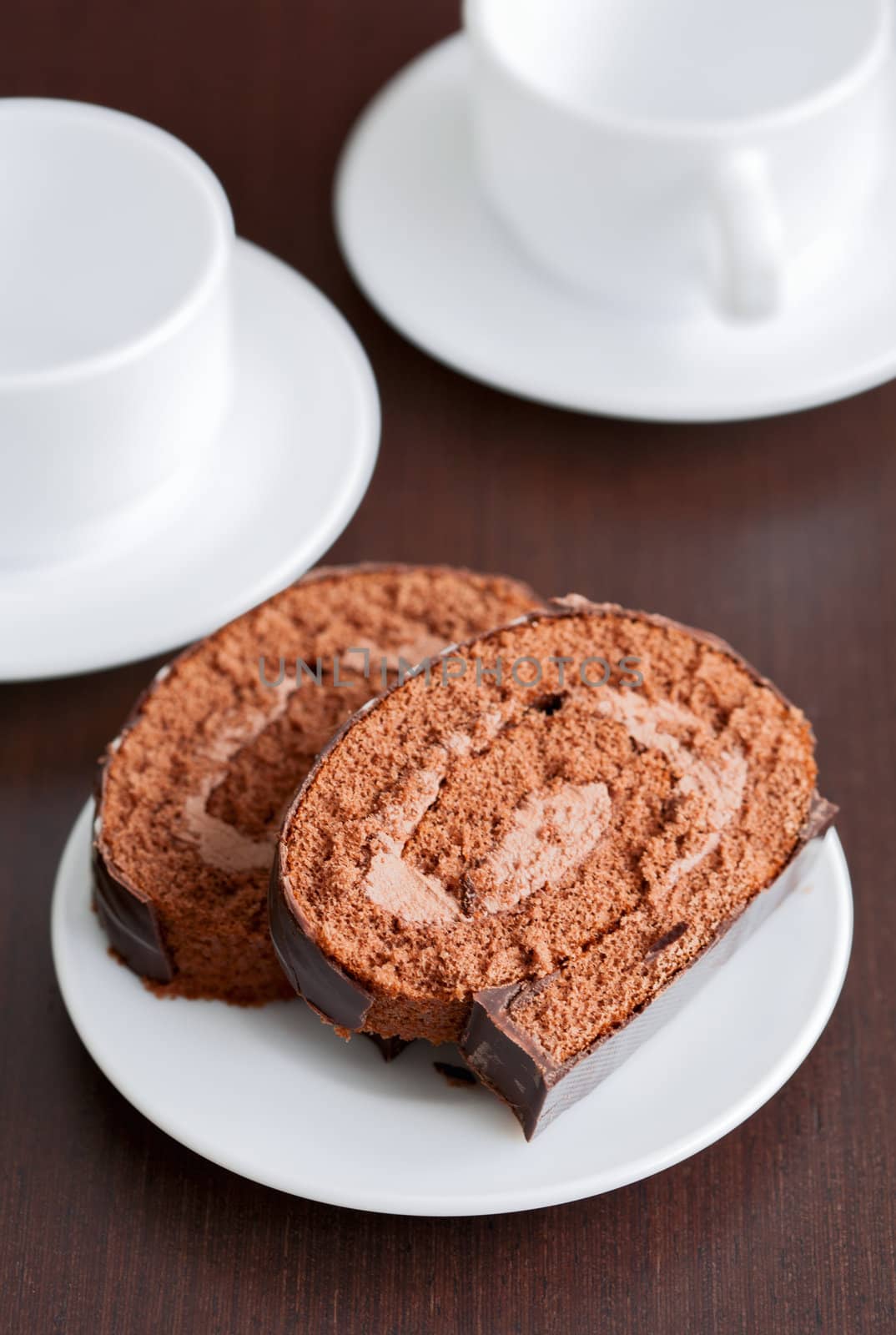 two slices of tasty chocolate cake on a plate by sfinks
