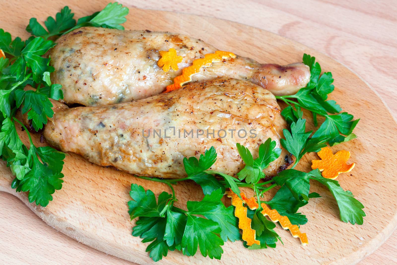 Fried chicken legs with parsley on the board by sfinks