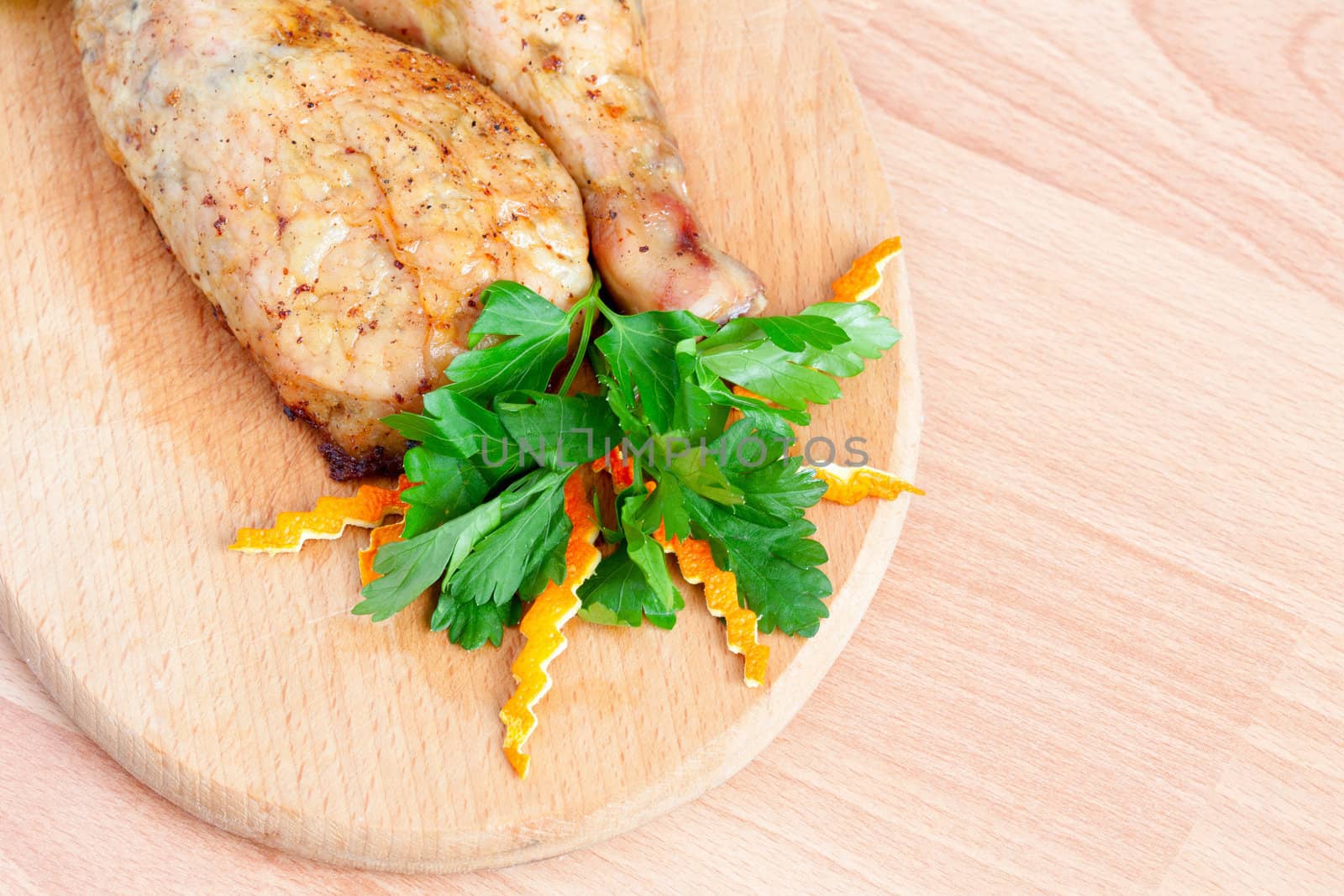 Fried chicken legs with parsley on the board by sfinks