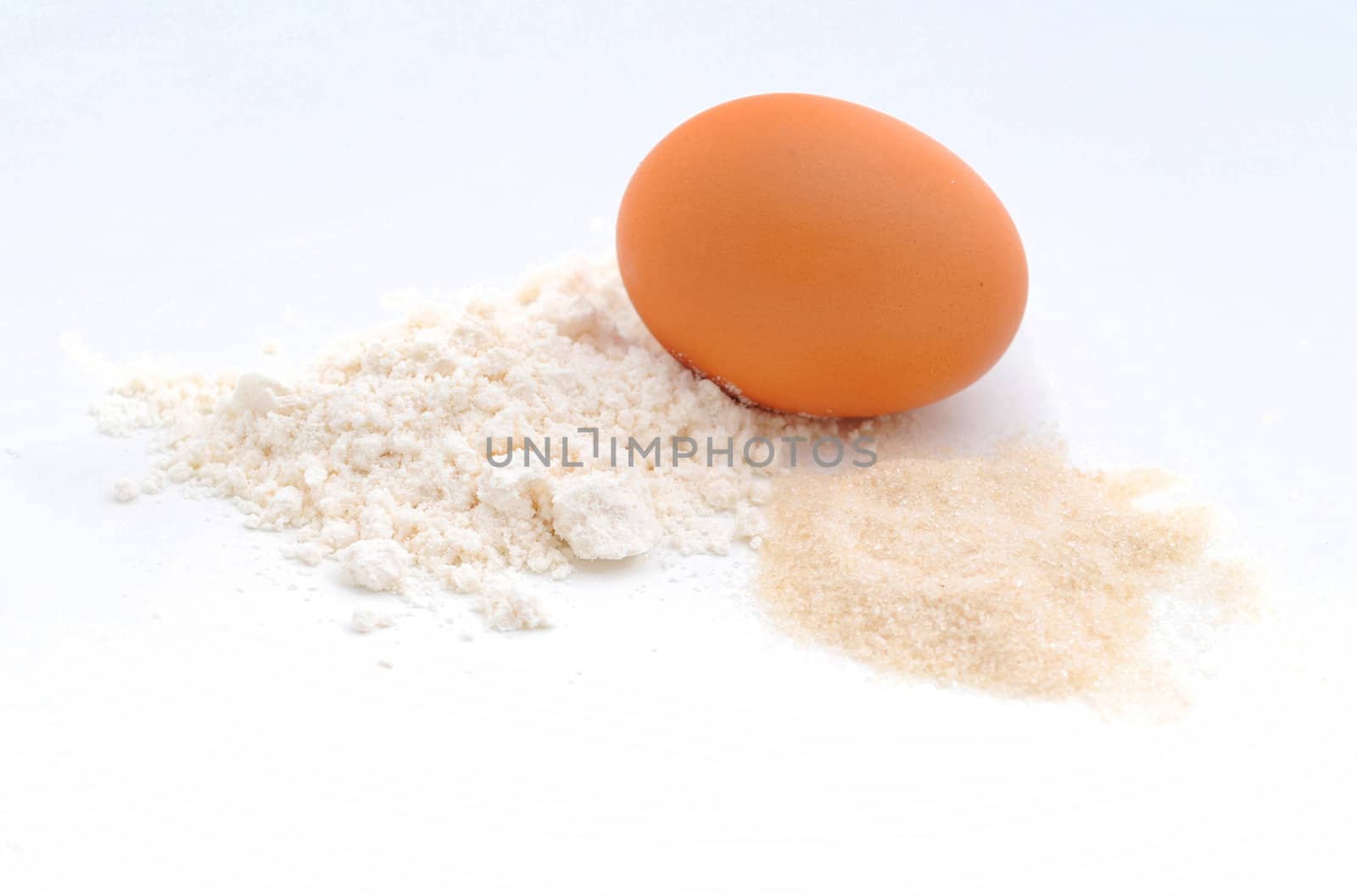 raw ingredients for baking which consists of an egg, flour and sugar