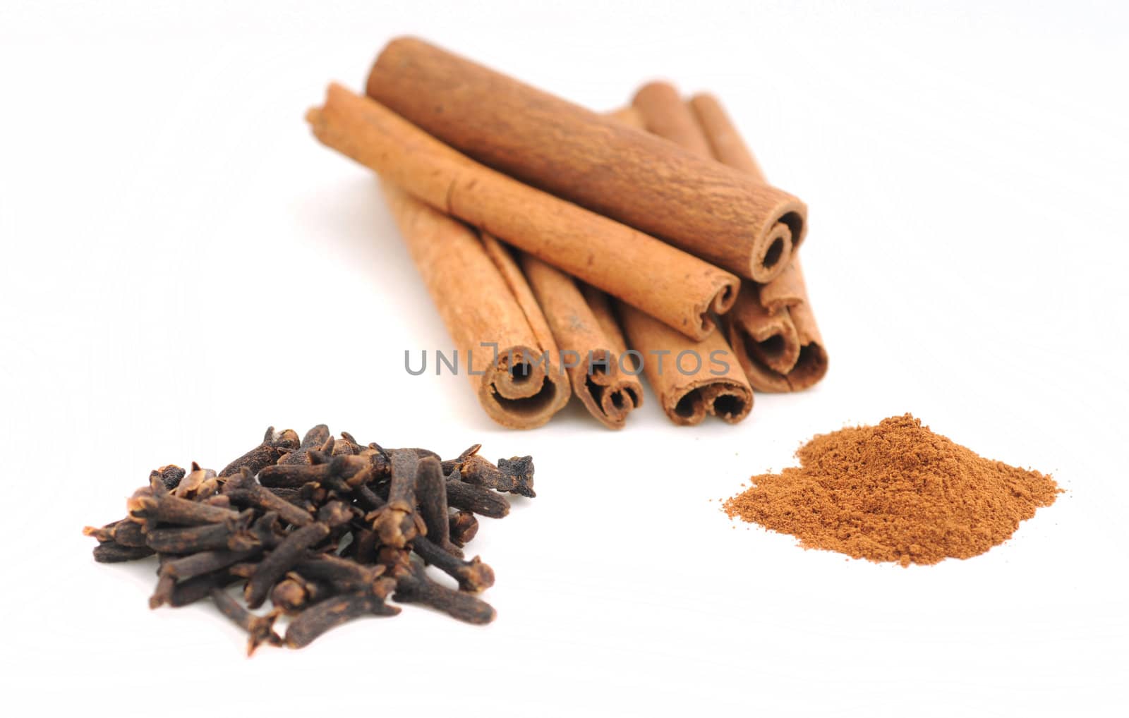 Cinnamon sticks and cloves on white background