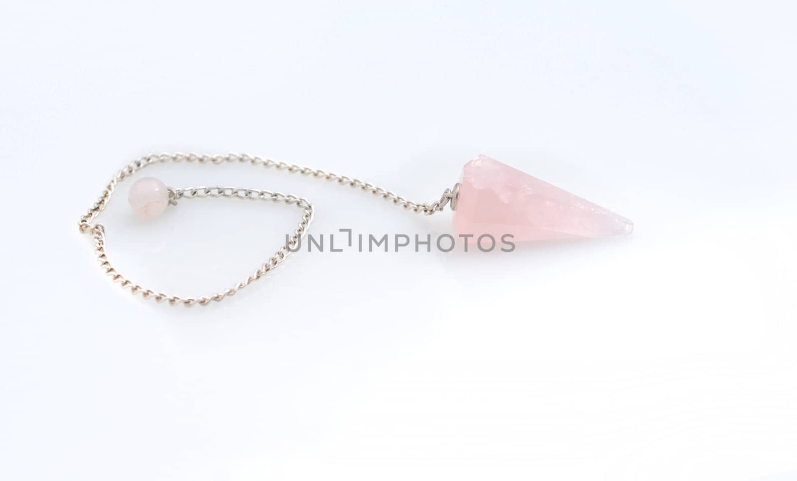 new age crystal pendulum accessory that is a pink rose quartz stone