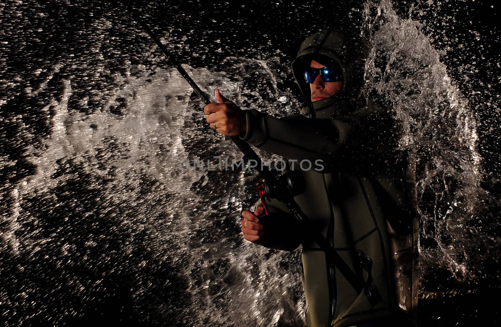 main in rain wearing jacket and holding fishing rod