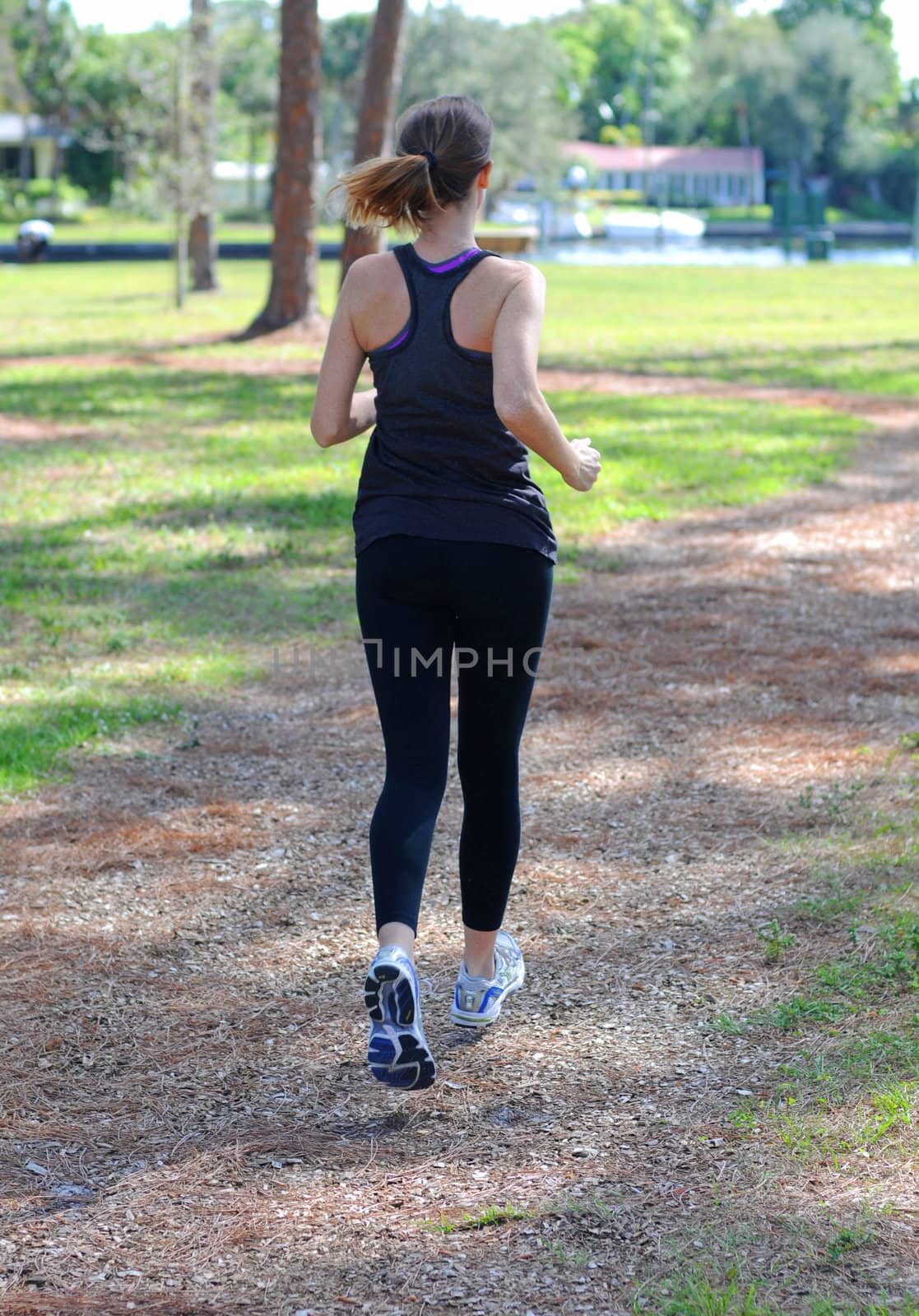 woman running outside in summer for fitness by ftlaudgirl